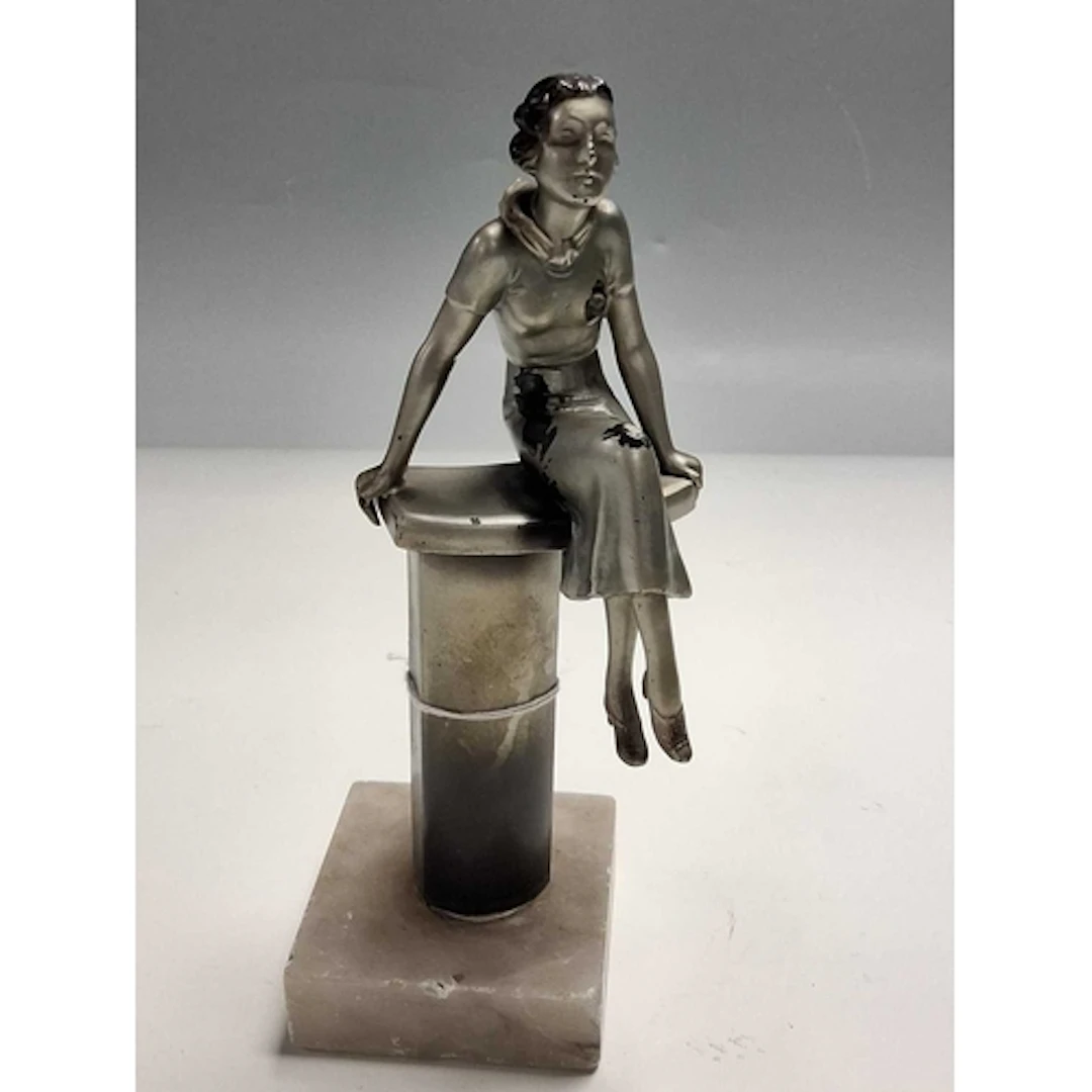 A COATED METAL FIGURE OF A SEATED LADY, in 1930s style, the ...