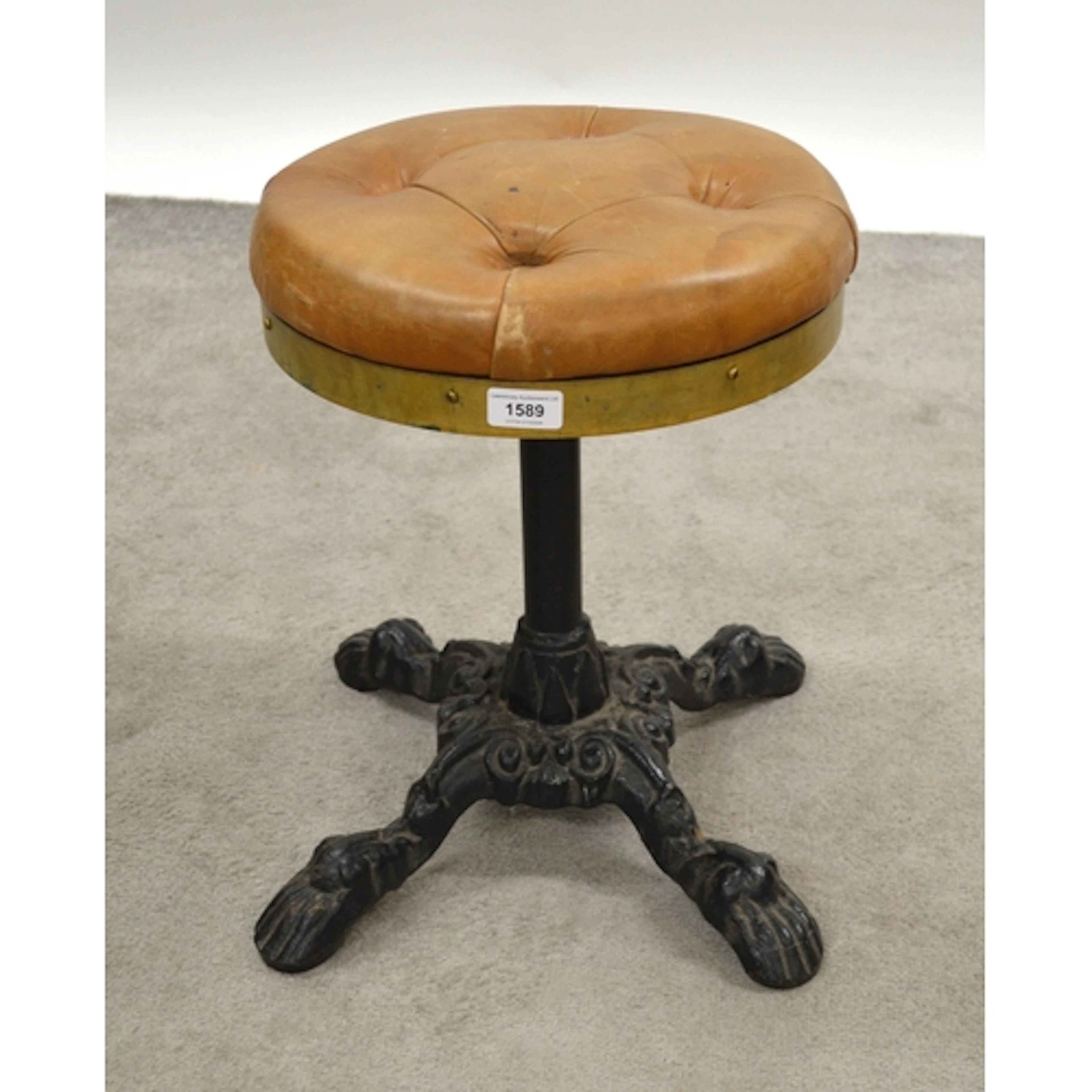 Pair of buttoned leather upholstered stools, with cast iron ...