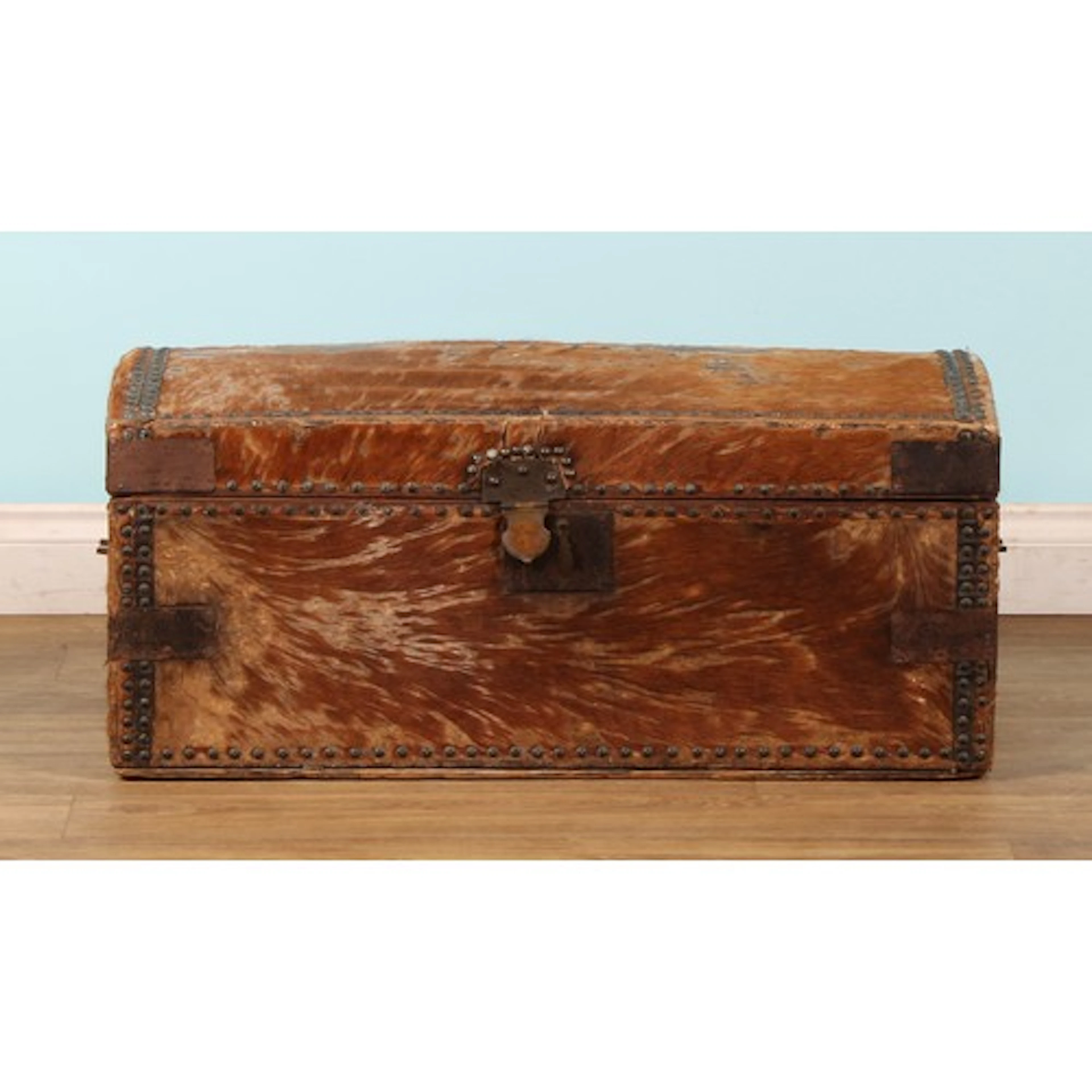 An early 19th century deer hide mounted dome top trunk, hing...
