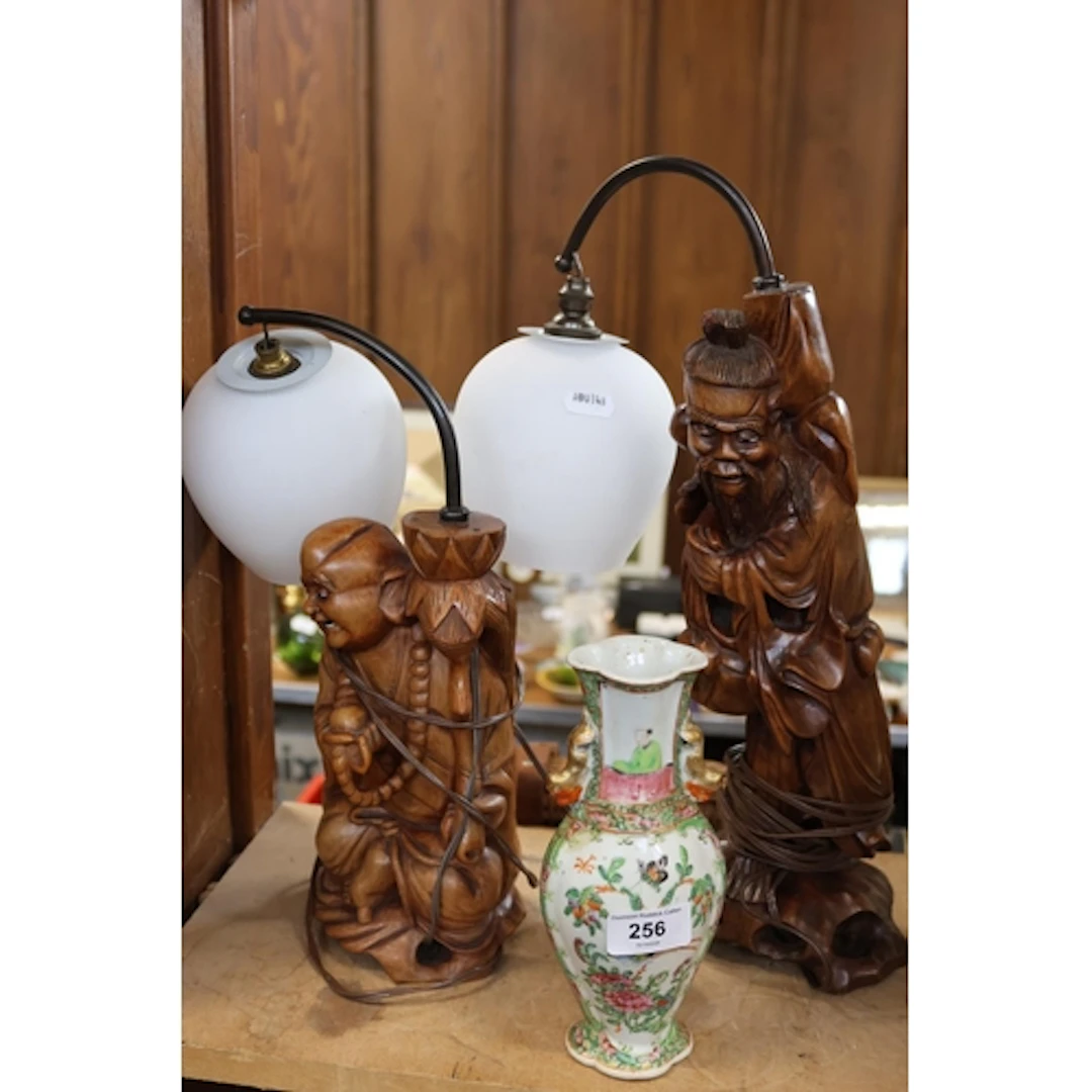 Two oriental carved lamps with opaque shades along with an o...