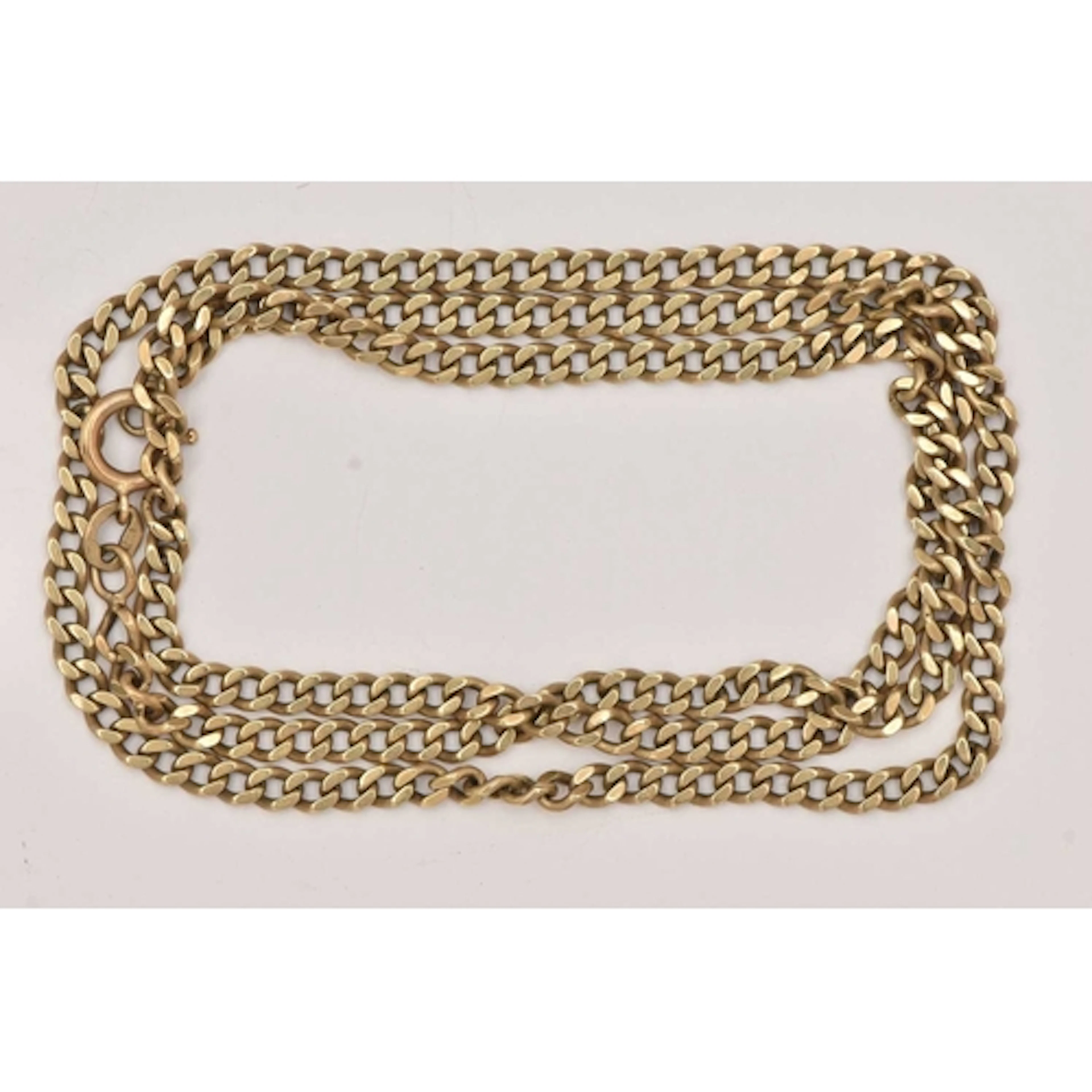 A YELLOW METAL CURB LINK CHAIN NECKLACE, fitted with a sprin...