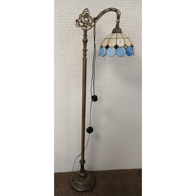 Brass floor standing lamp with Tiffany style shade.