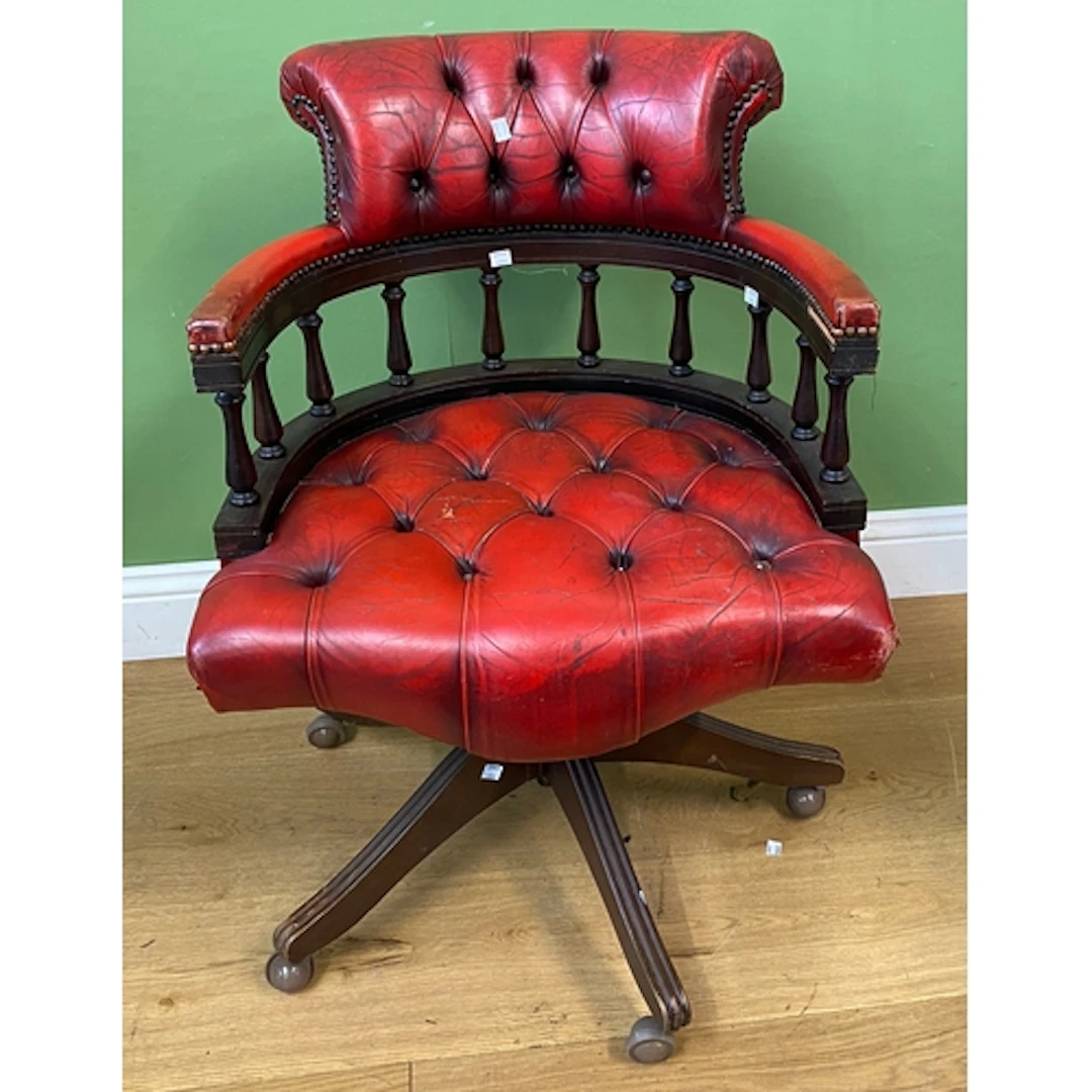 A red leather and close nailed button upholstered swivel des...