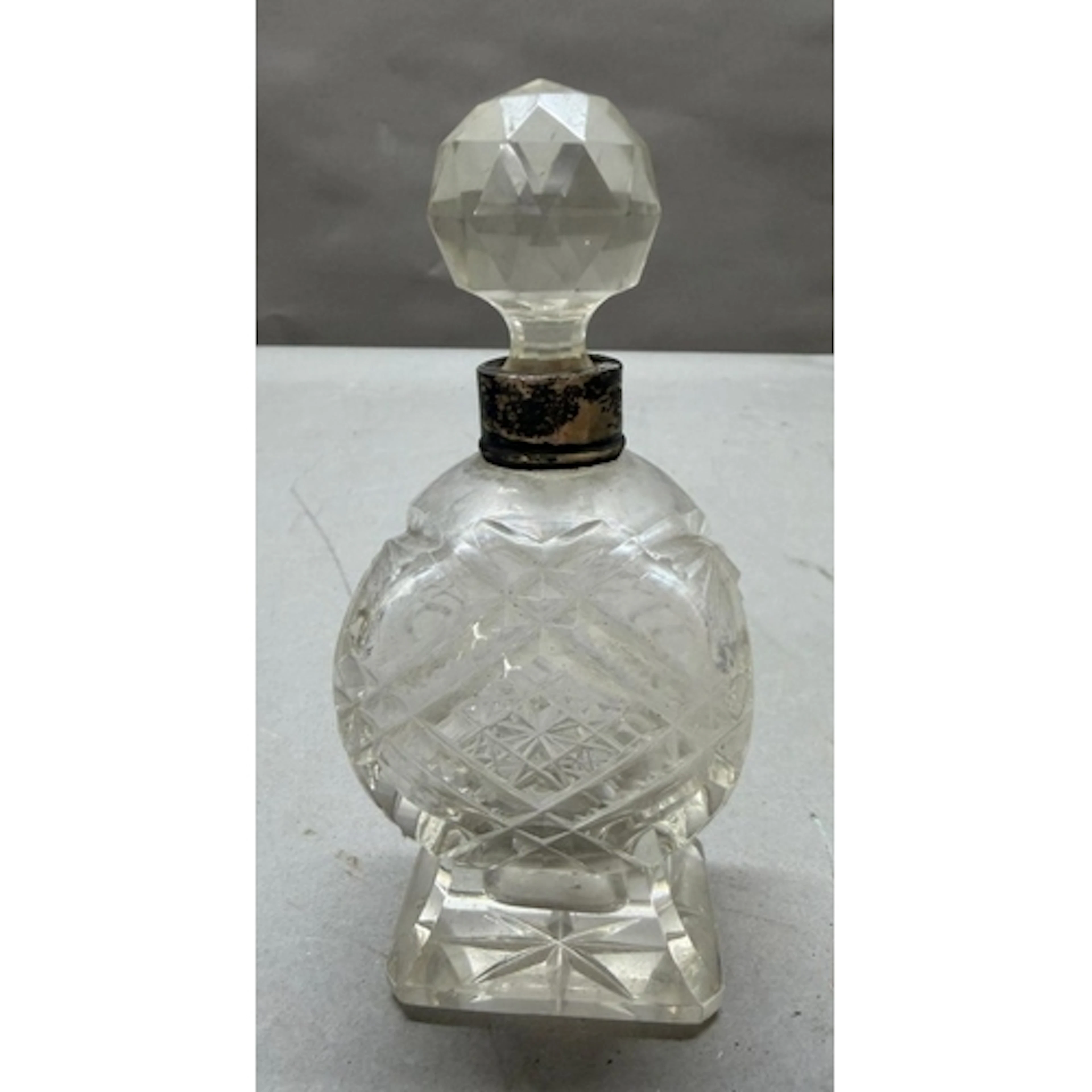 Cut glass scent bottle with hallmarked silver collar.