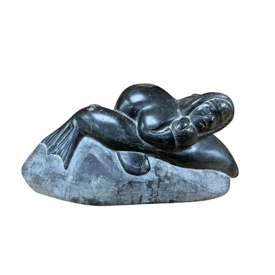 An Inuit carved stone group of a fisherman attacking a seal,...
