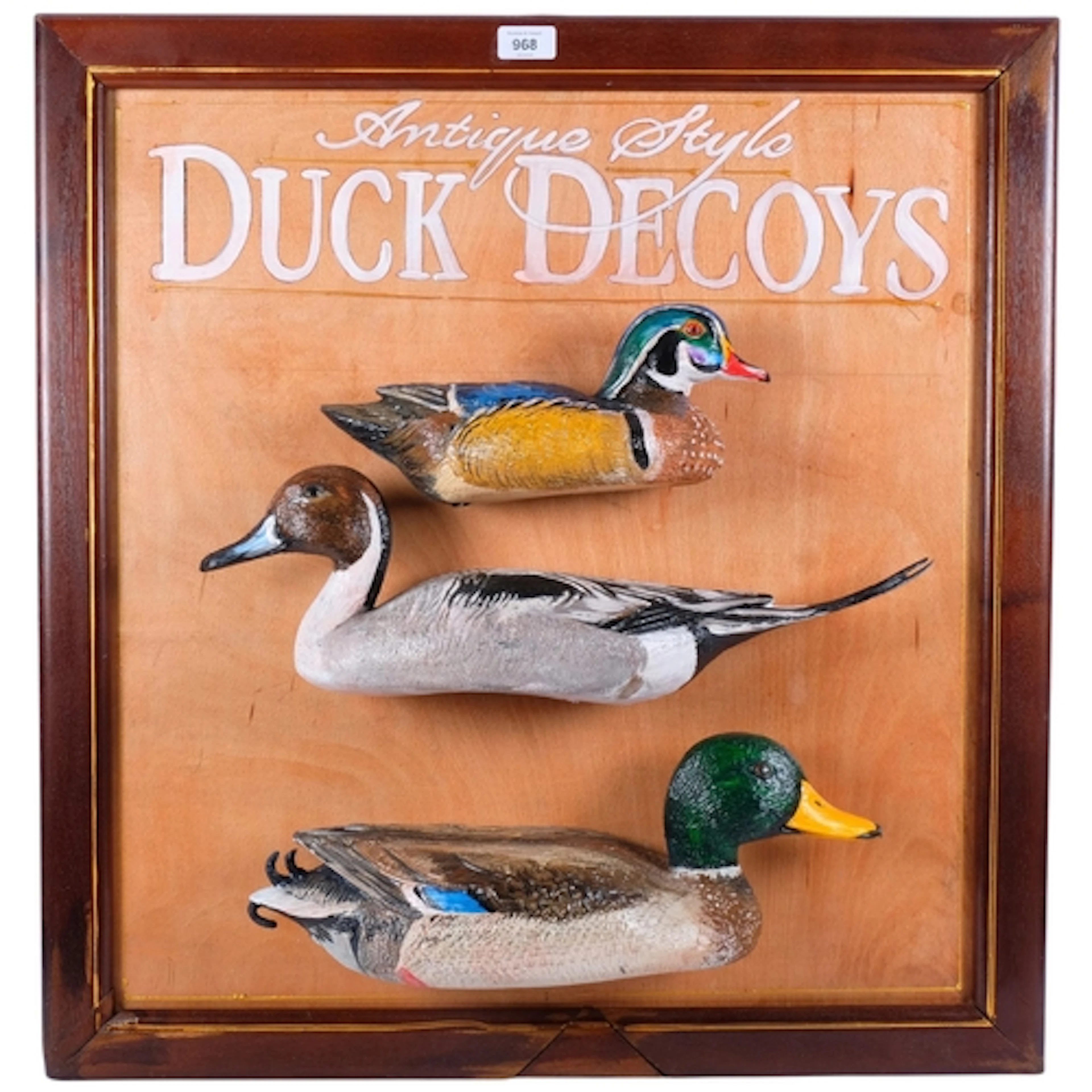 A group of 3 colourful painted ducks, mounted on a display b...