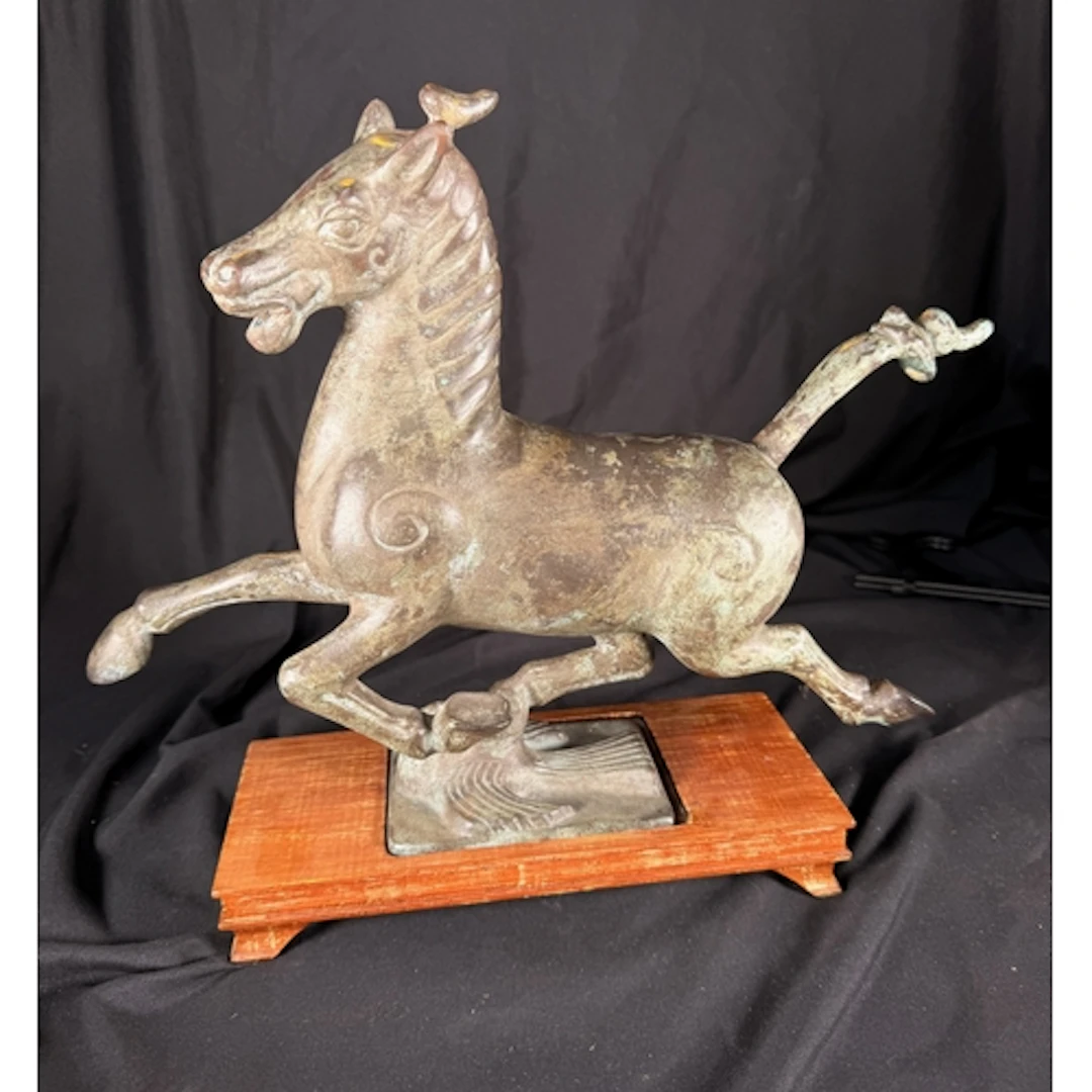 A Tang style Chinese bronze horse on wooden stand