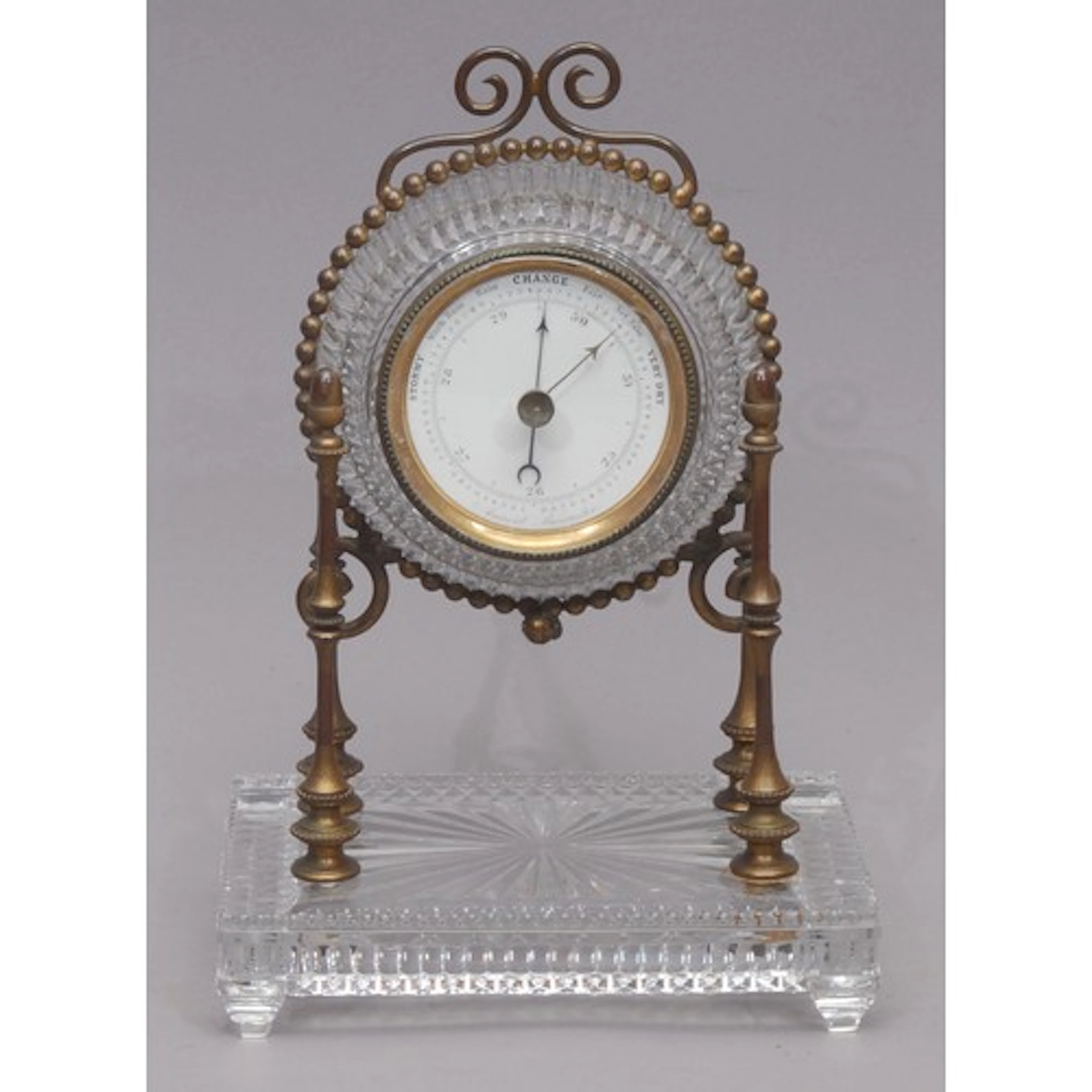 An early 20th century glass table top aneroid portico barome...