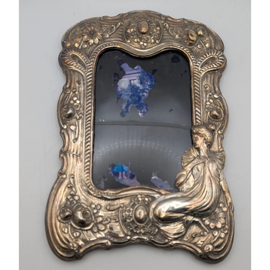 A white metal fronted easel back photograph frame A/F, featu...