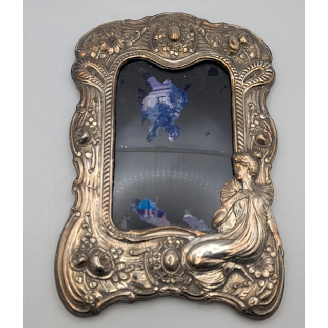 A white metal fronted easel back photograph frame A/F, featu...
