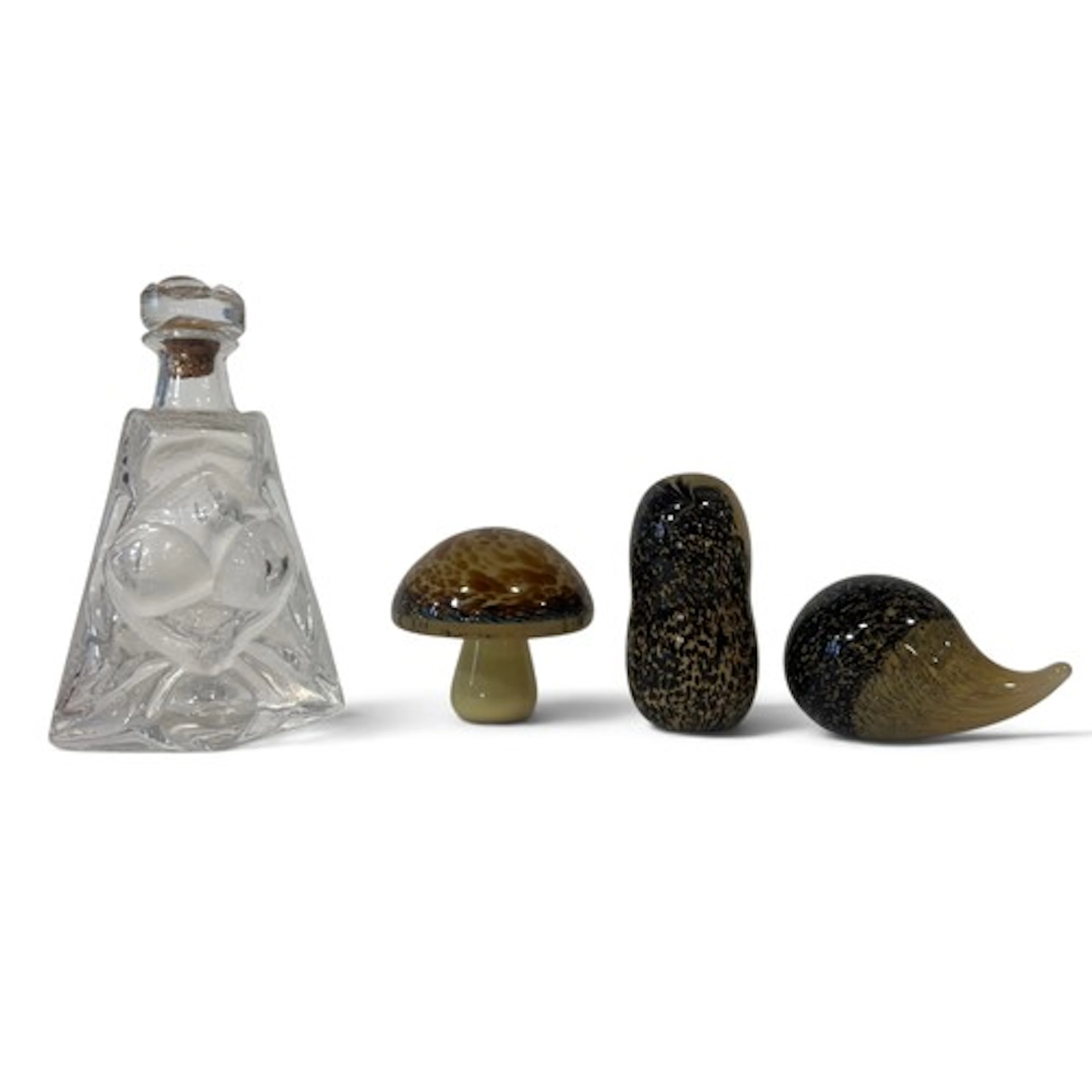 Three Wedgwood glass paperweights and a moulded glass decant...