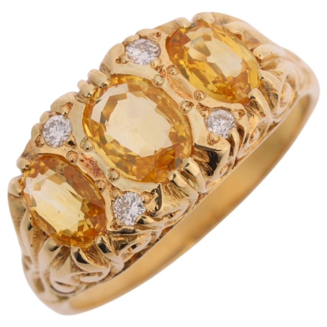 An 18ct gold seven stone yellow sapphire and diamond half ho...