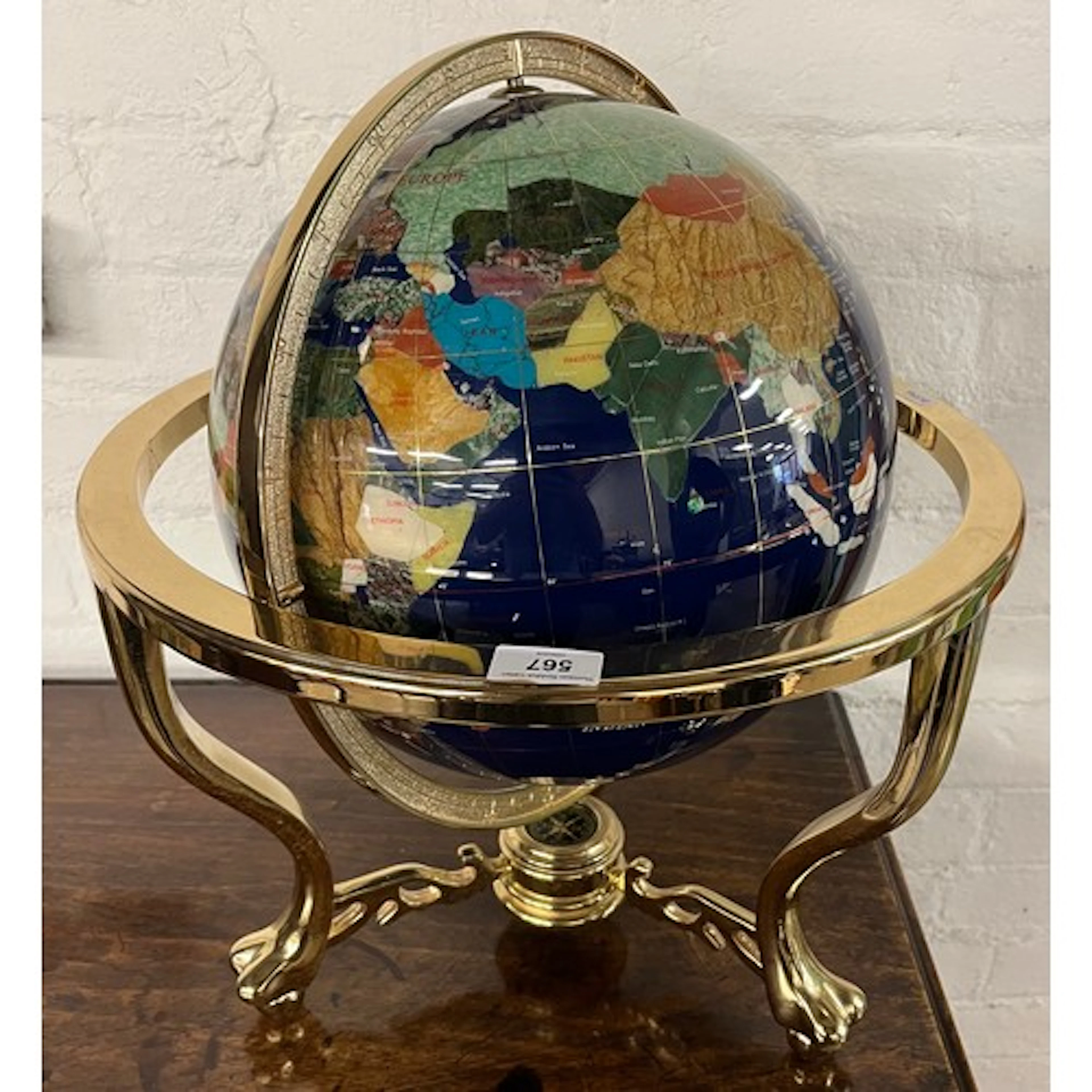 Brass mounted gemstone world globe.