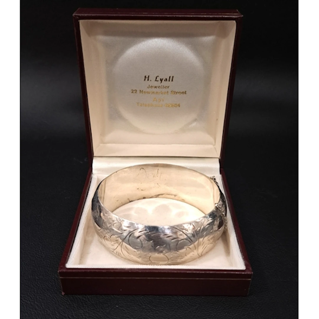 VICTORIAN STYLE SILVER BANGLE with engraved scroll decoratio...