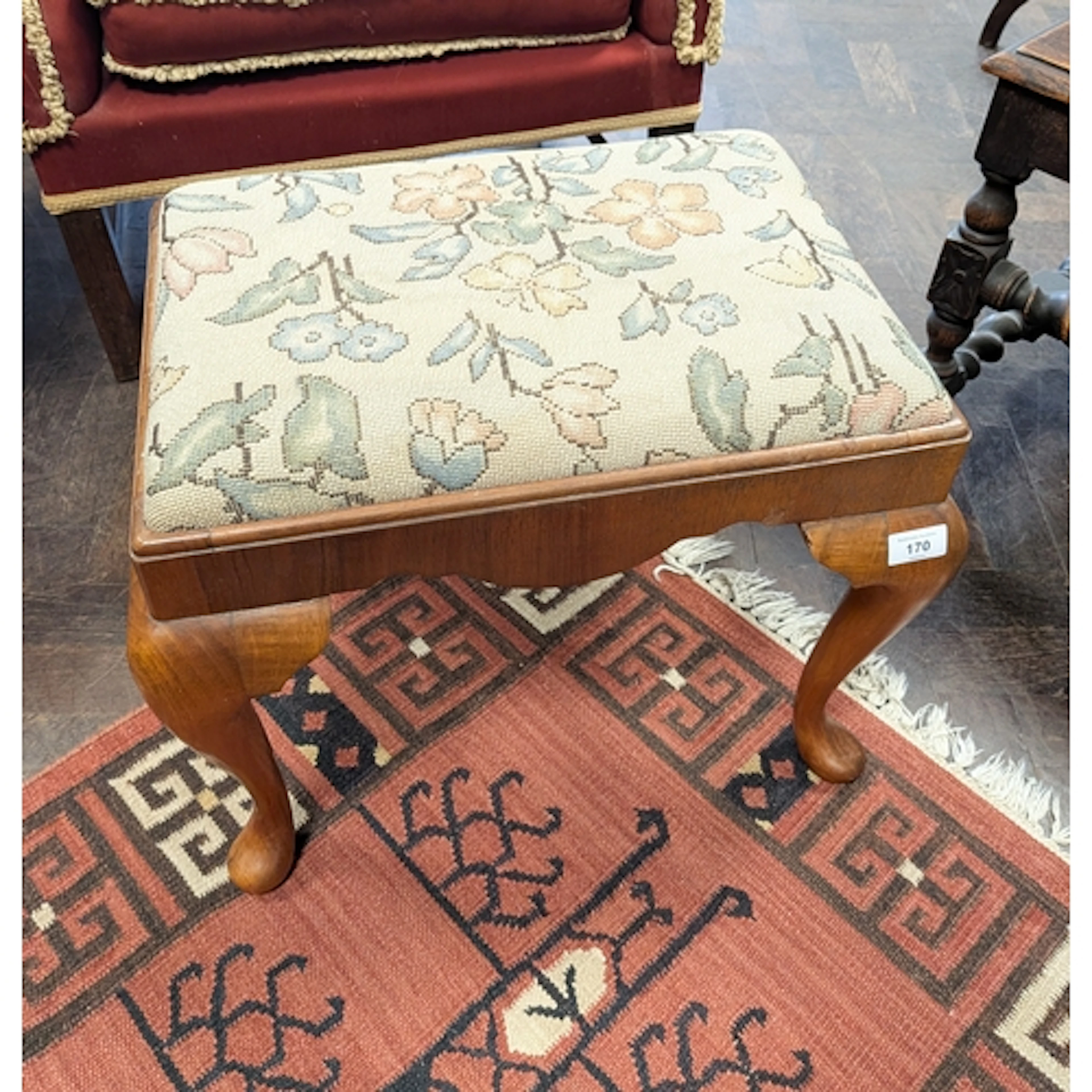 A walnut framed dressing stool on cabriole legs with tapestr...