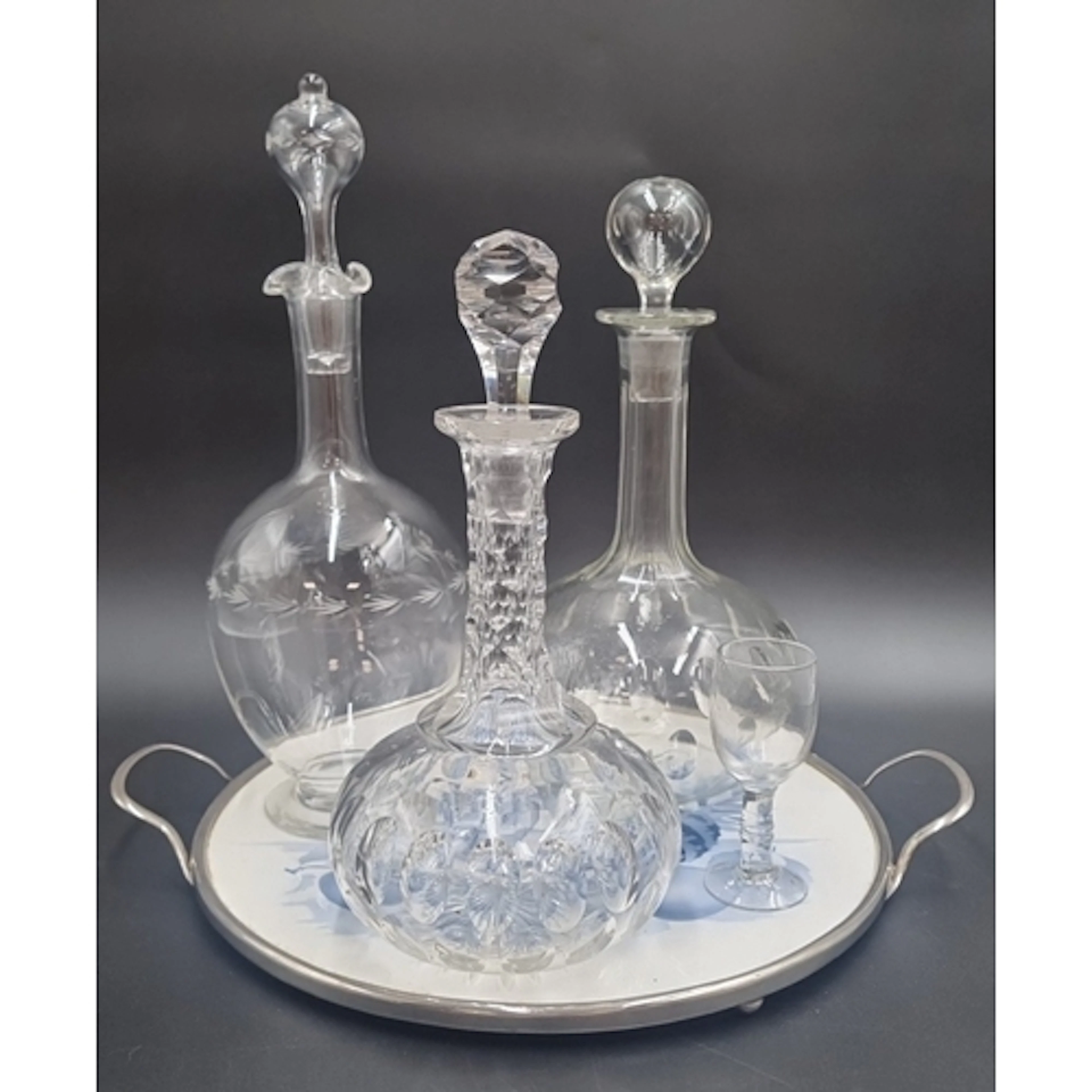 Lot of three glass and cut-glass decanters with stoppers, a ...