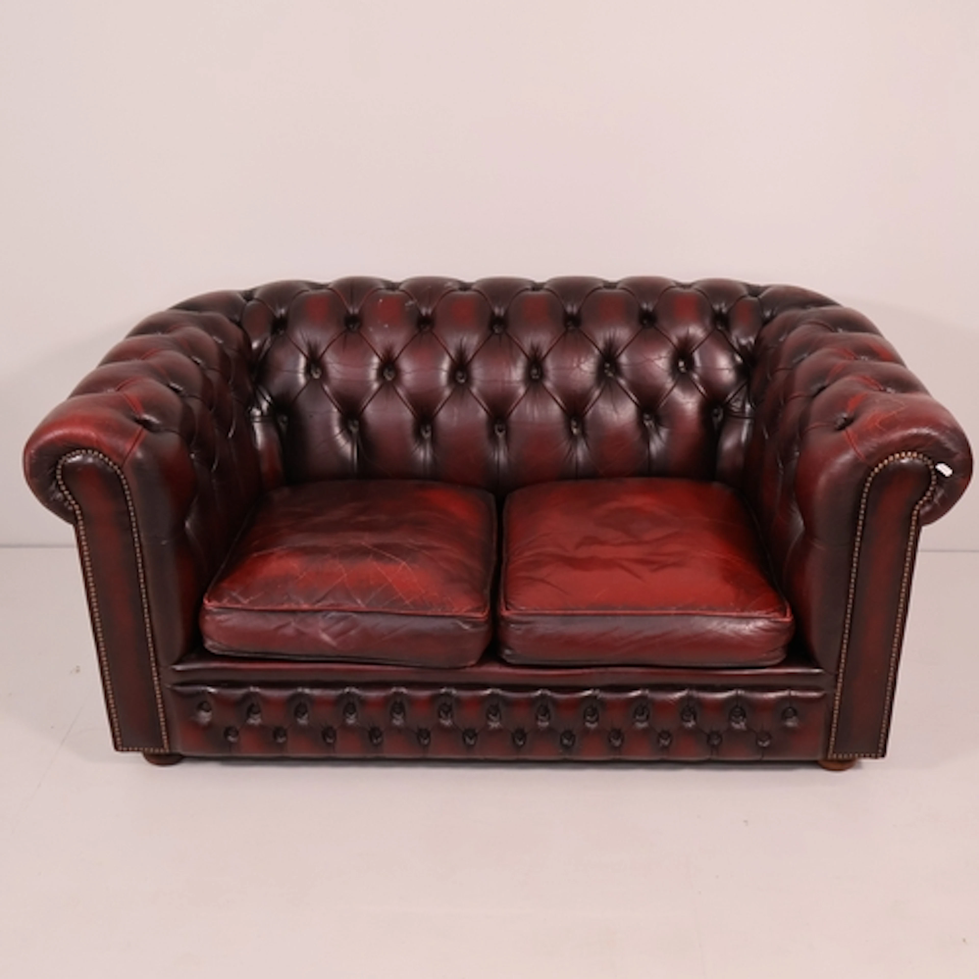 A modern two-seater Chesterfield style button-back and studd...
