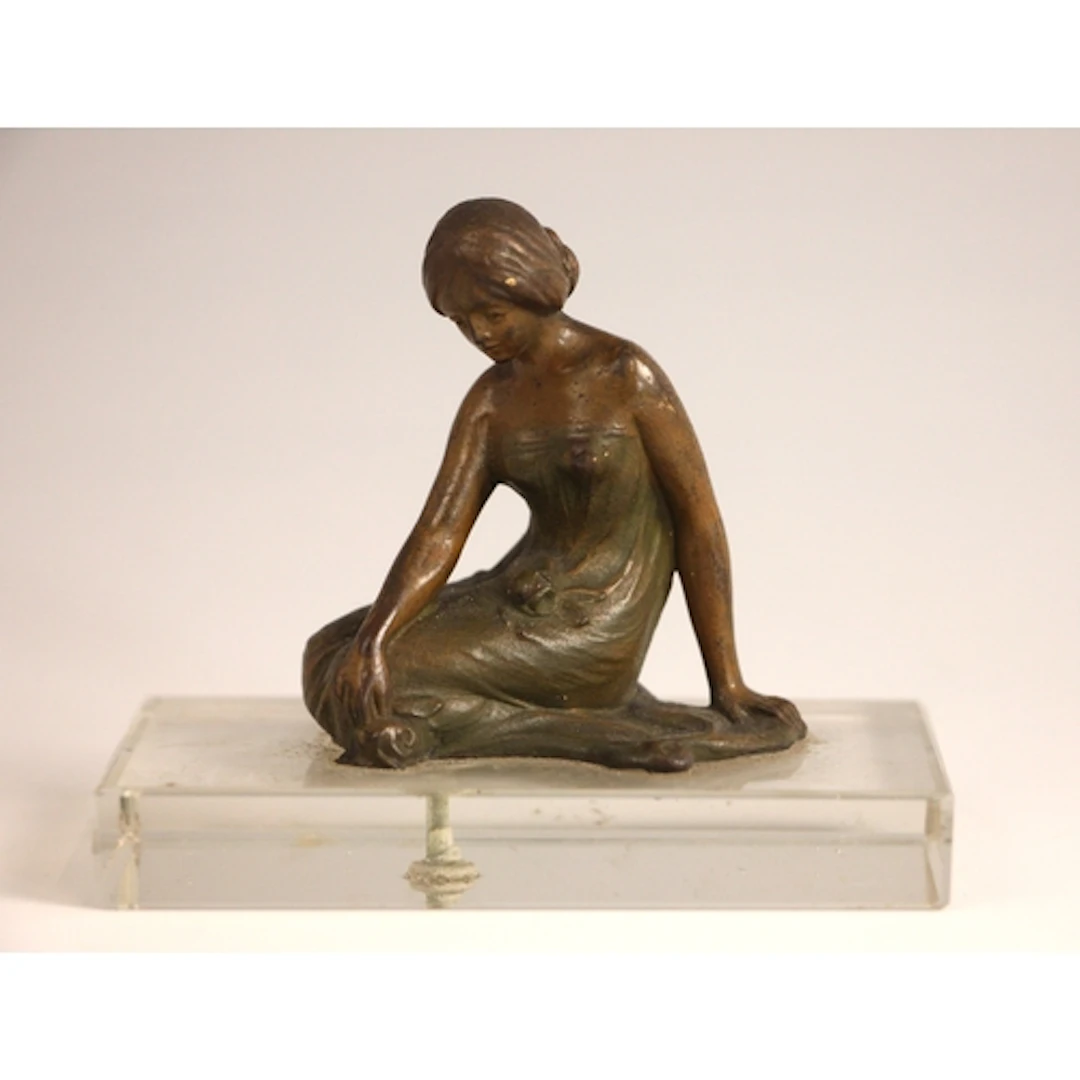 A patinated bronze Art Nouveau style figure of small proport...