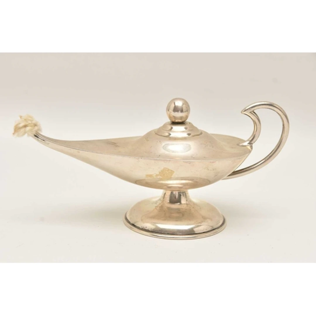 A WHITE METAL NOVELTY TABLE LIGHTER, in the form of an oil l...