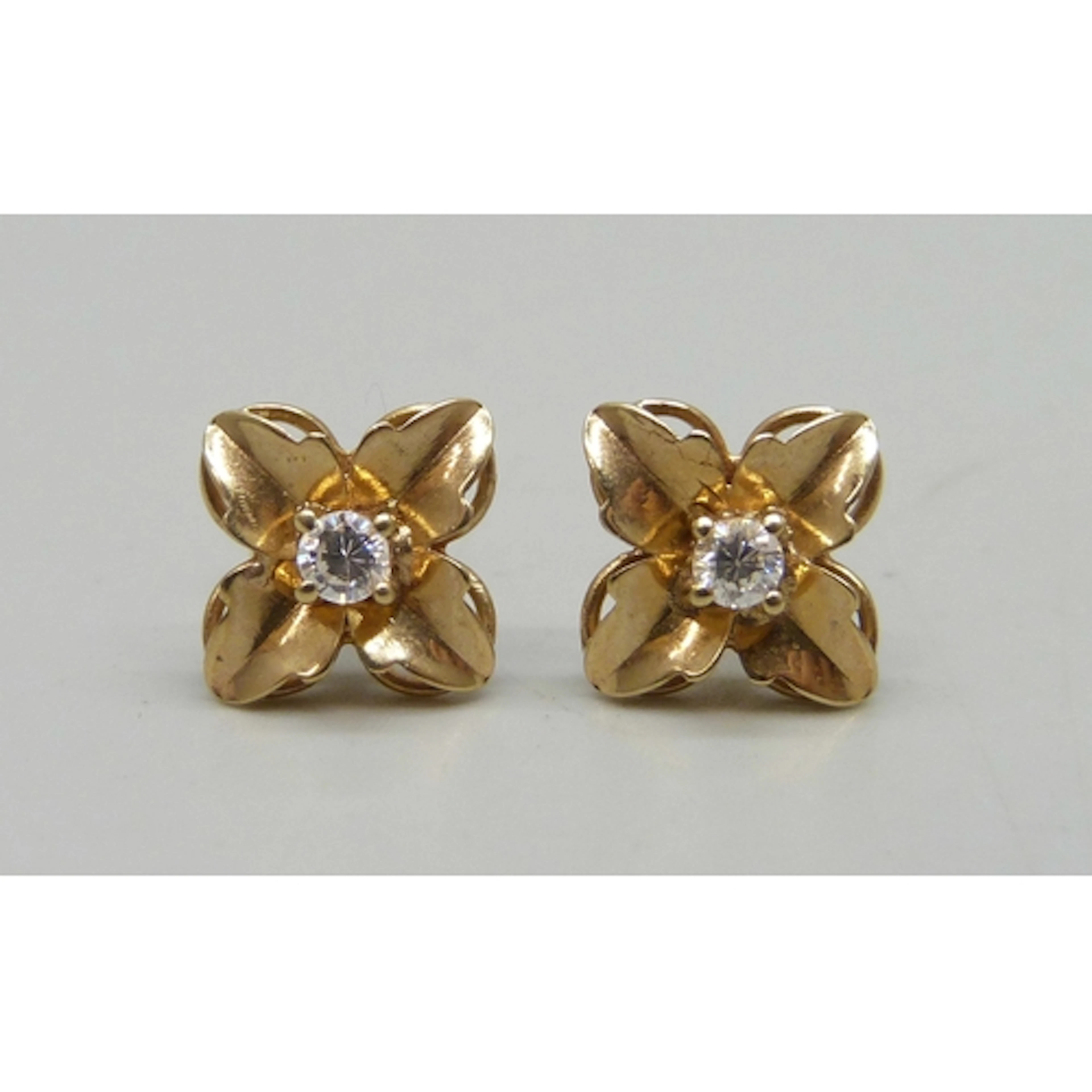 A pair of 9ct gold and white stone flower design stud earrin...