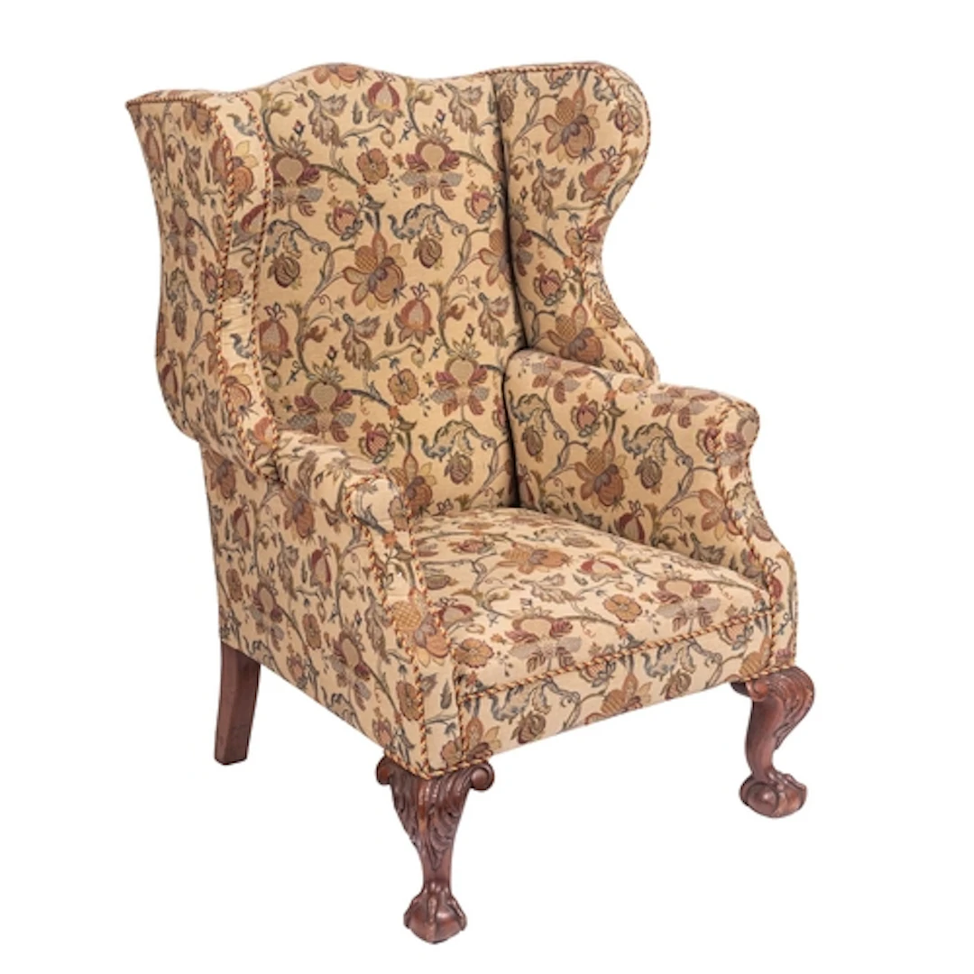 An upholstered wing armchair in George II style, early 20th ...