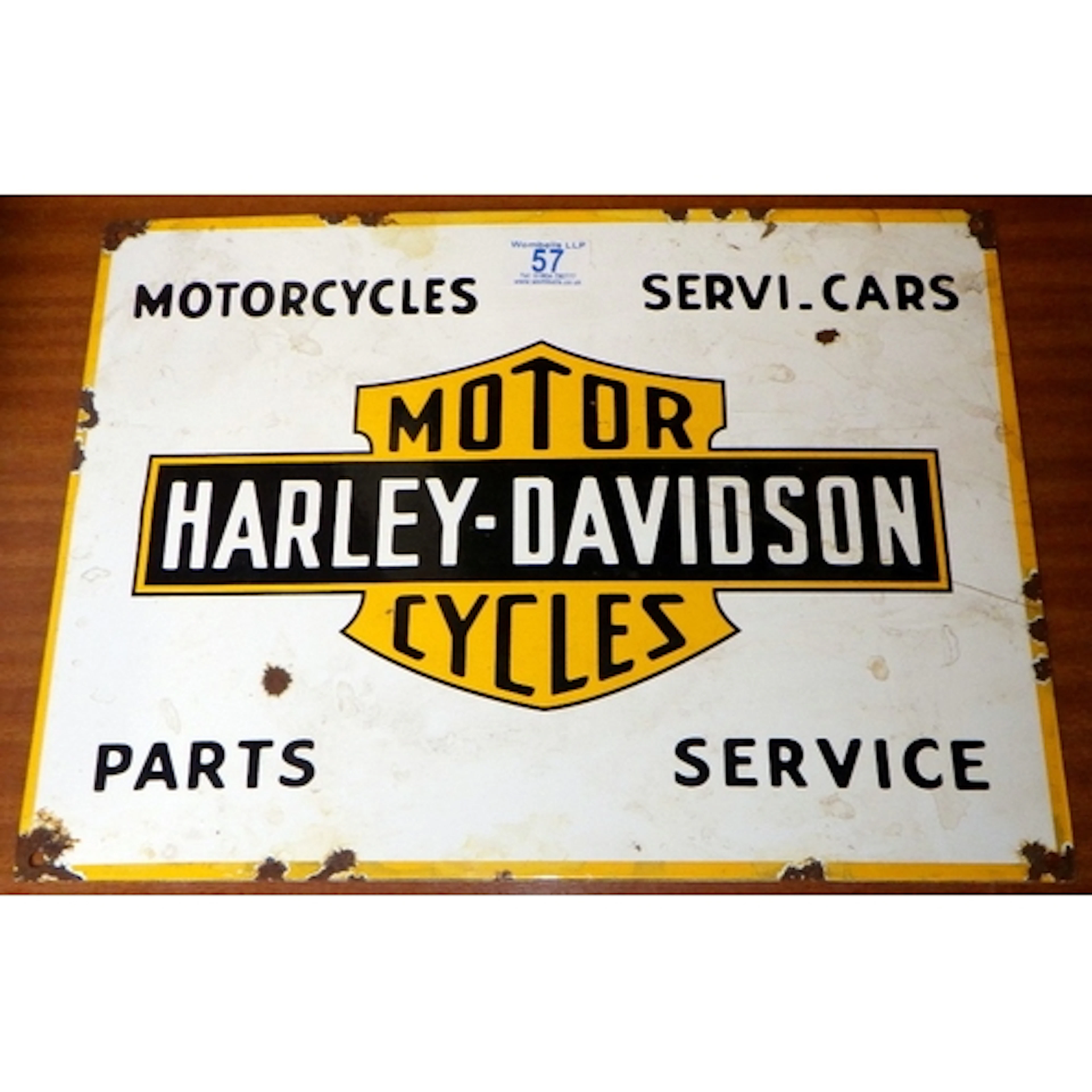 A reproduction enamel Harley Davidson Cycles sign