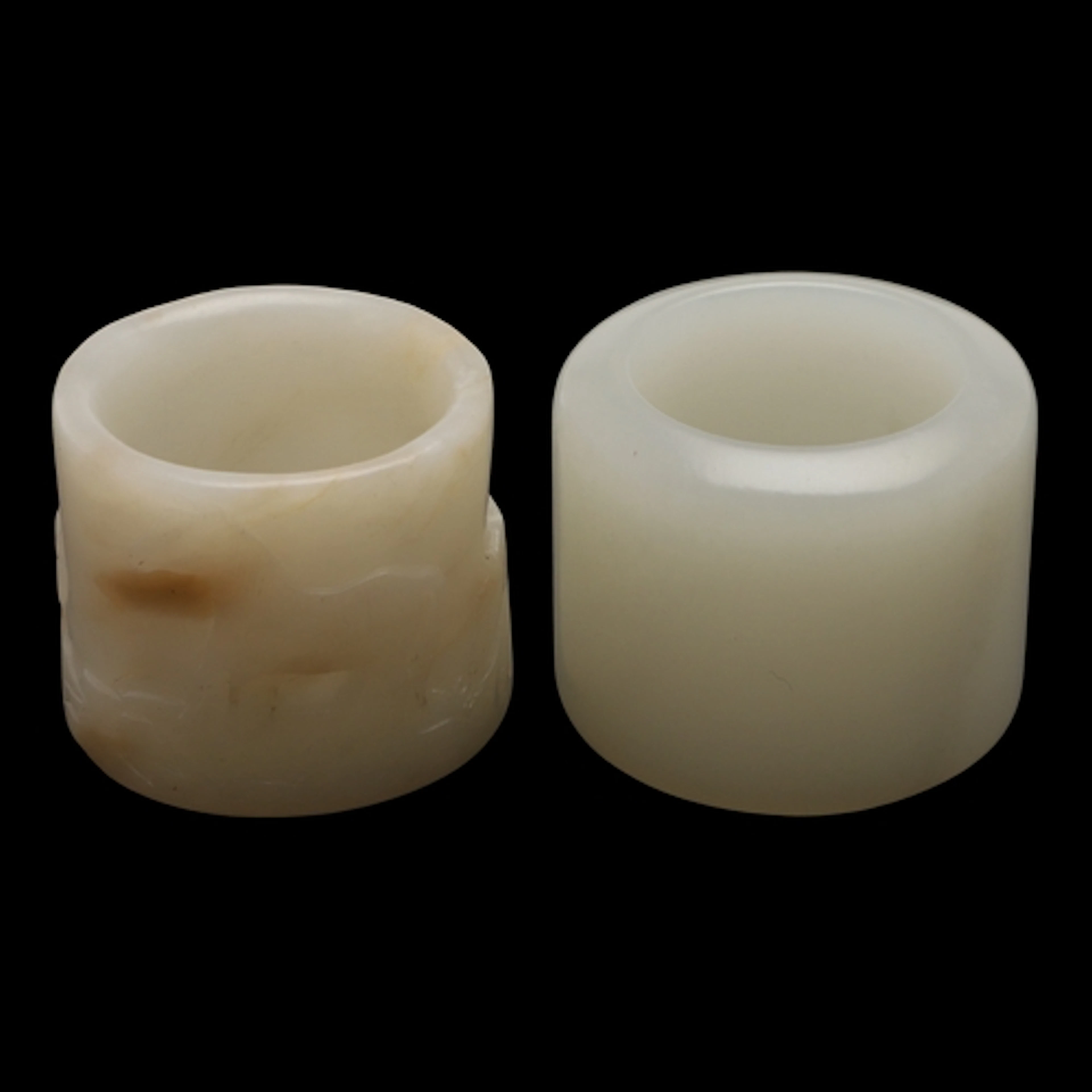 CHINESE JADE ARCHERS FINGER RINGS. Including a pale celadon ...