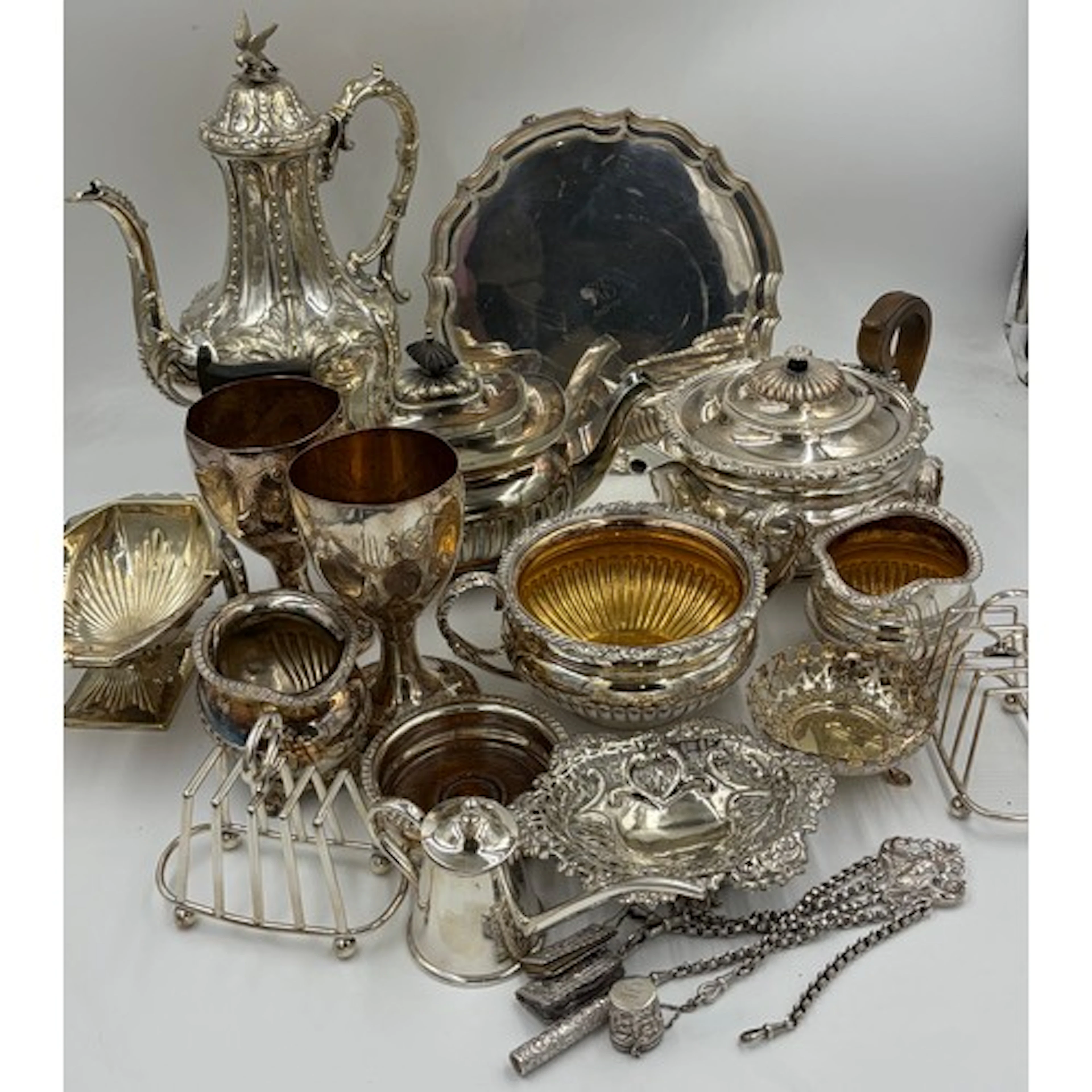 A collection of silverplate to include teapot, sugar and mil...
