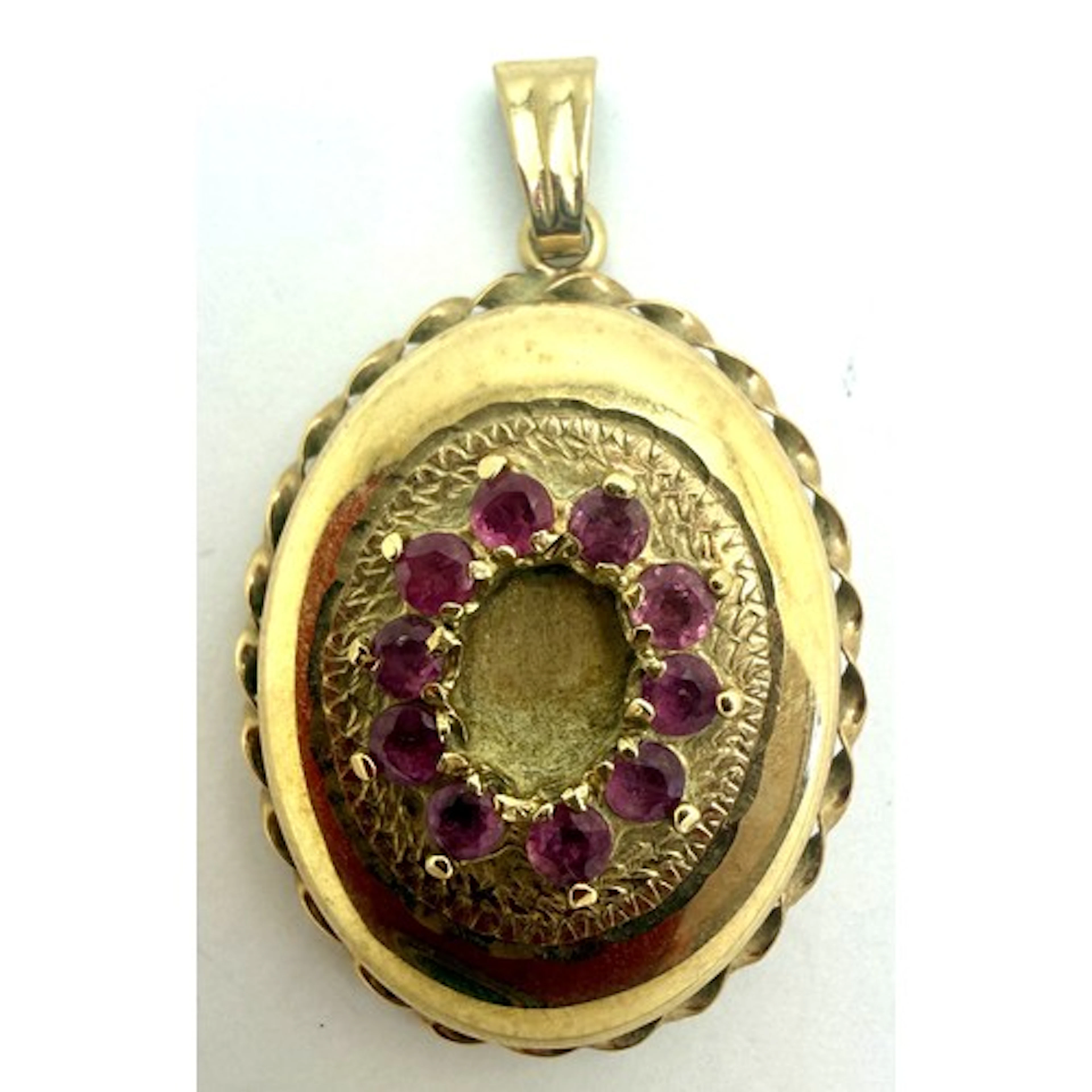 A 9 carat gold oval locket set with pink stones with etched ...