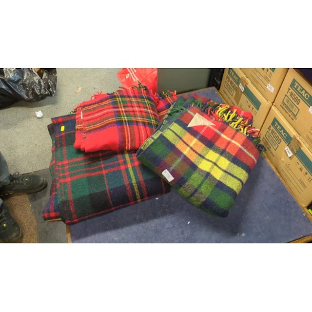 A group of tartan travel rugs in red, green and multicoloure...