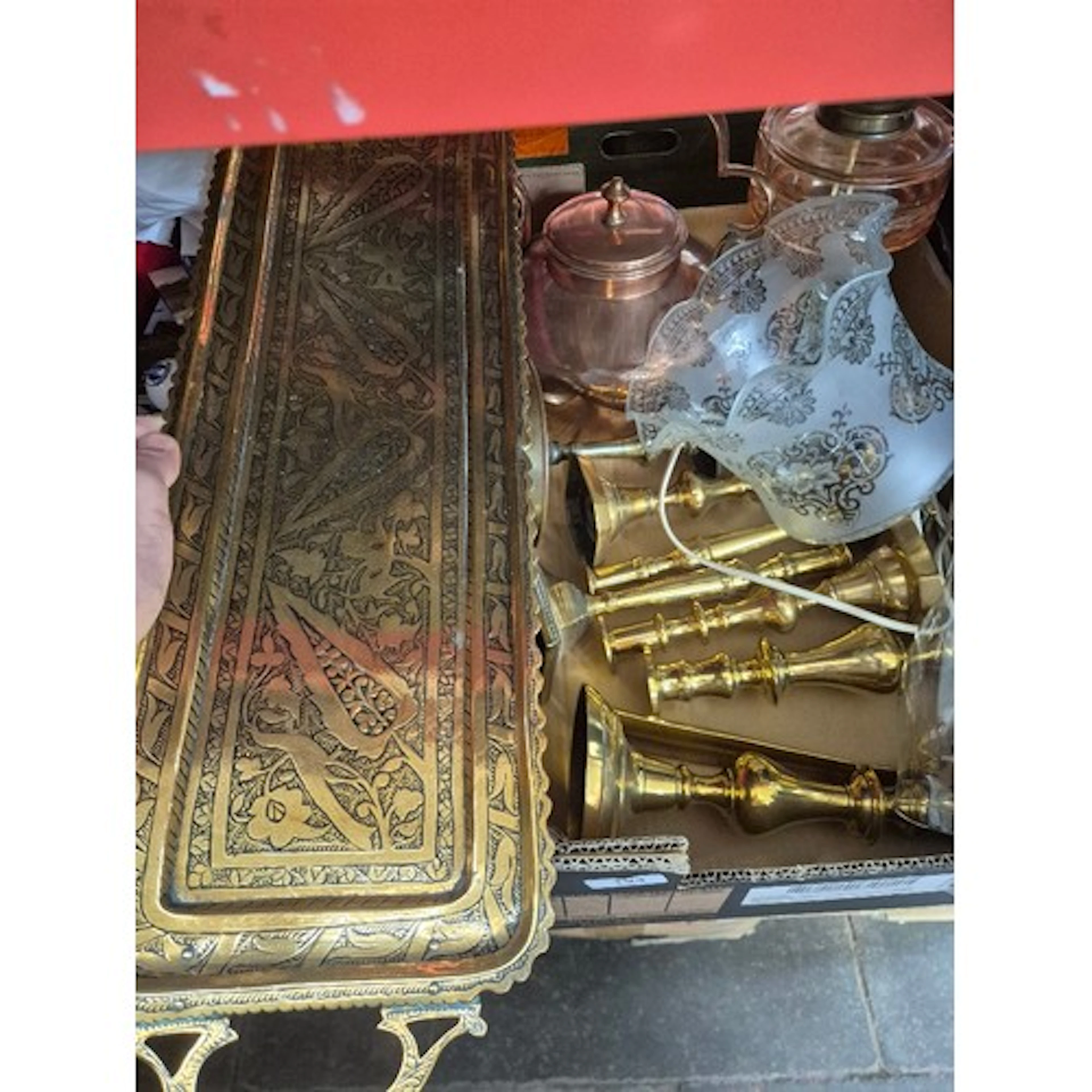 A box of mainly brass ware including an oil lamp with glass ...