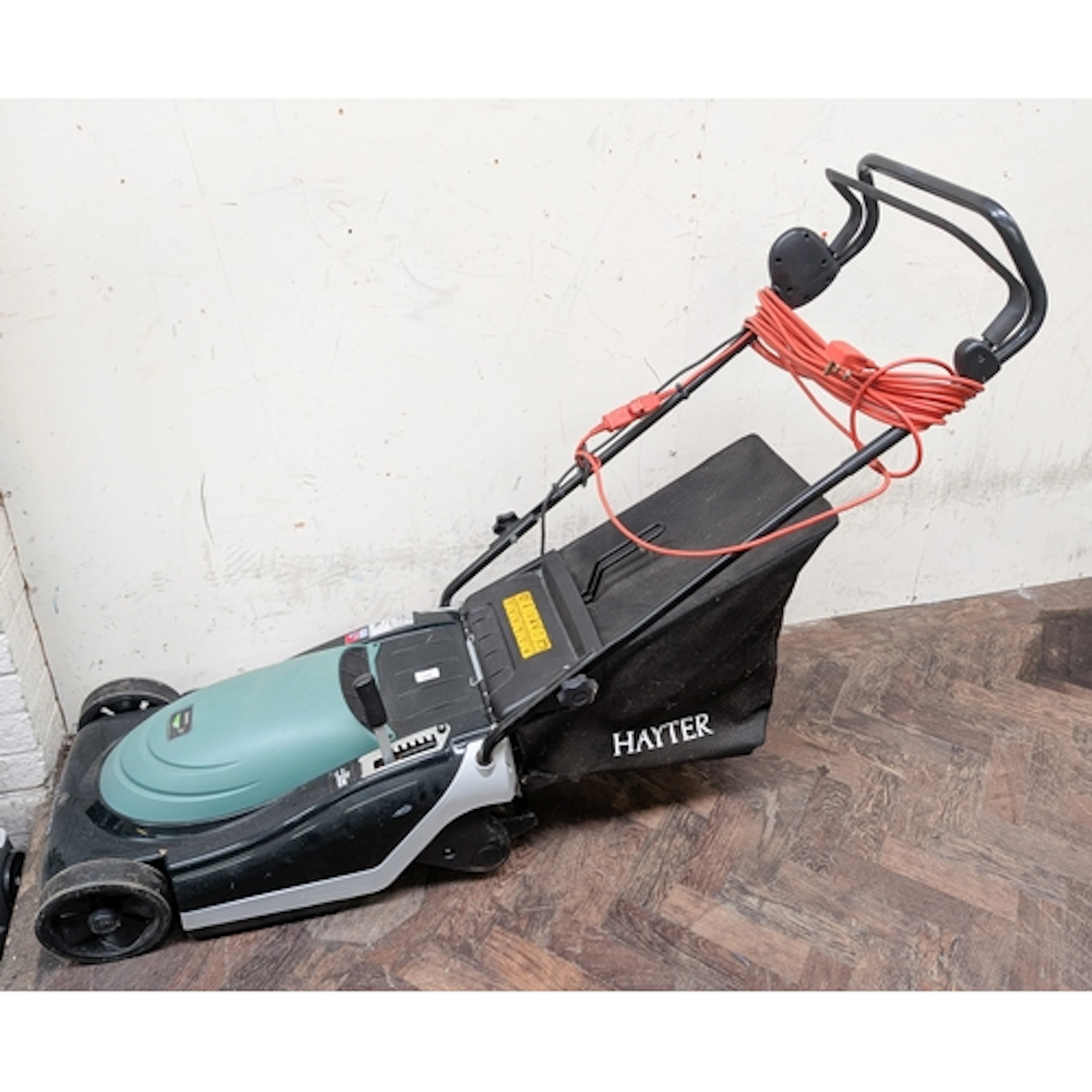 An electric Hayter lawn mower with roller and grass collecti...