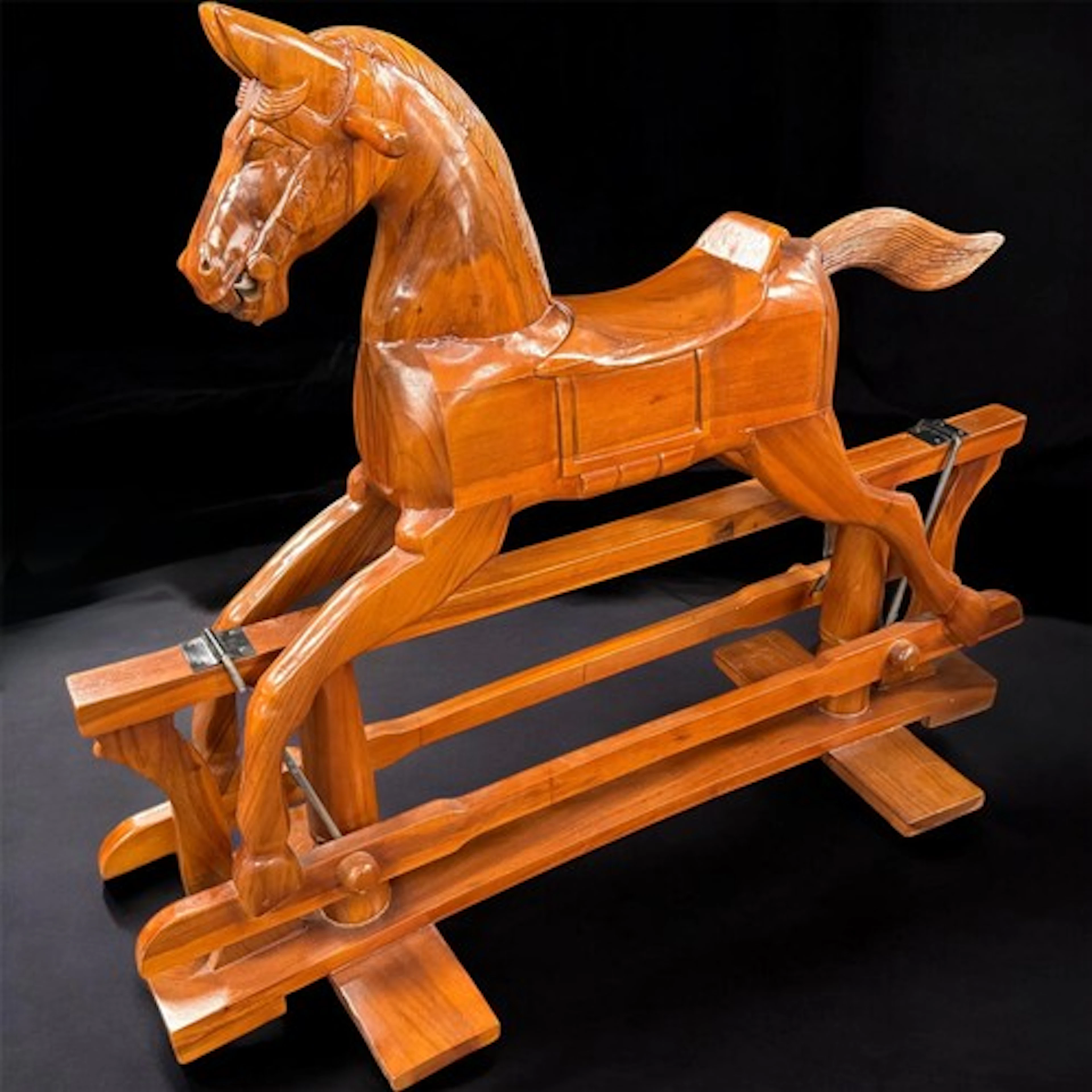 A large wooden rocking horse, 116cm high, 140cm long, 50cm w...