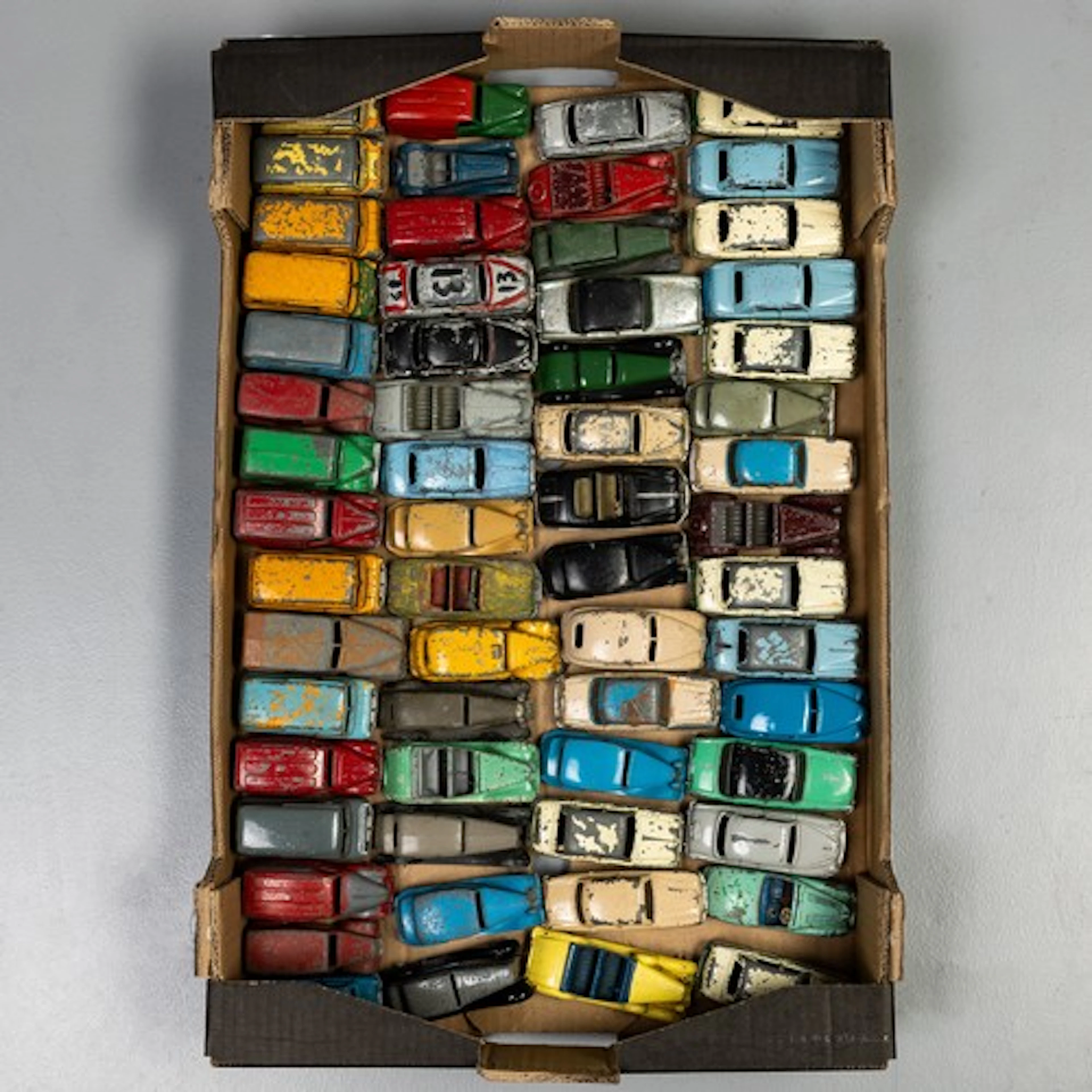 Fruit tray containing 60 unboxed early and later Dinky cars ...
