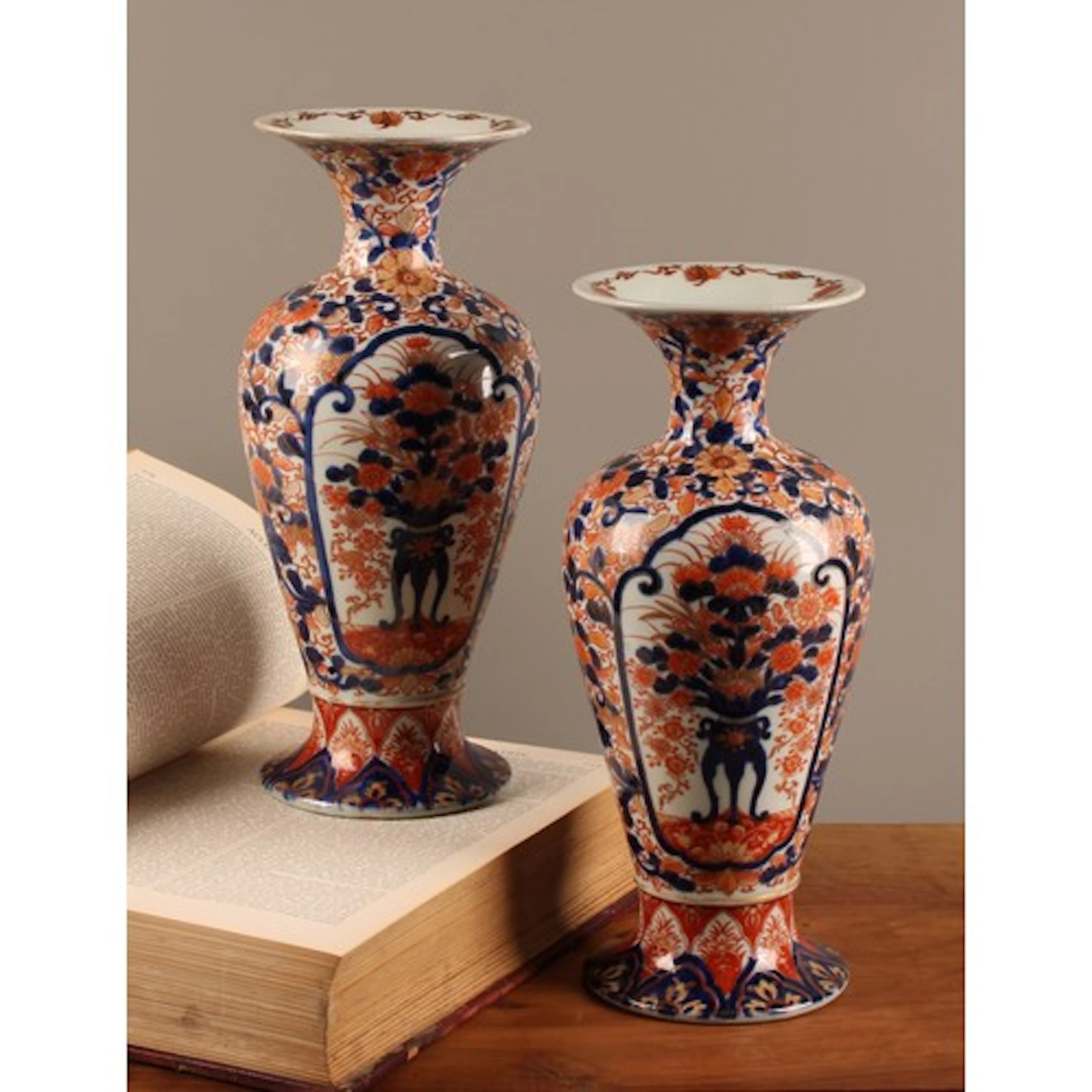A pair of Japanese porcelain baluster vases, decorated in th...