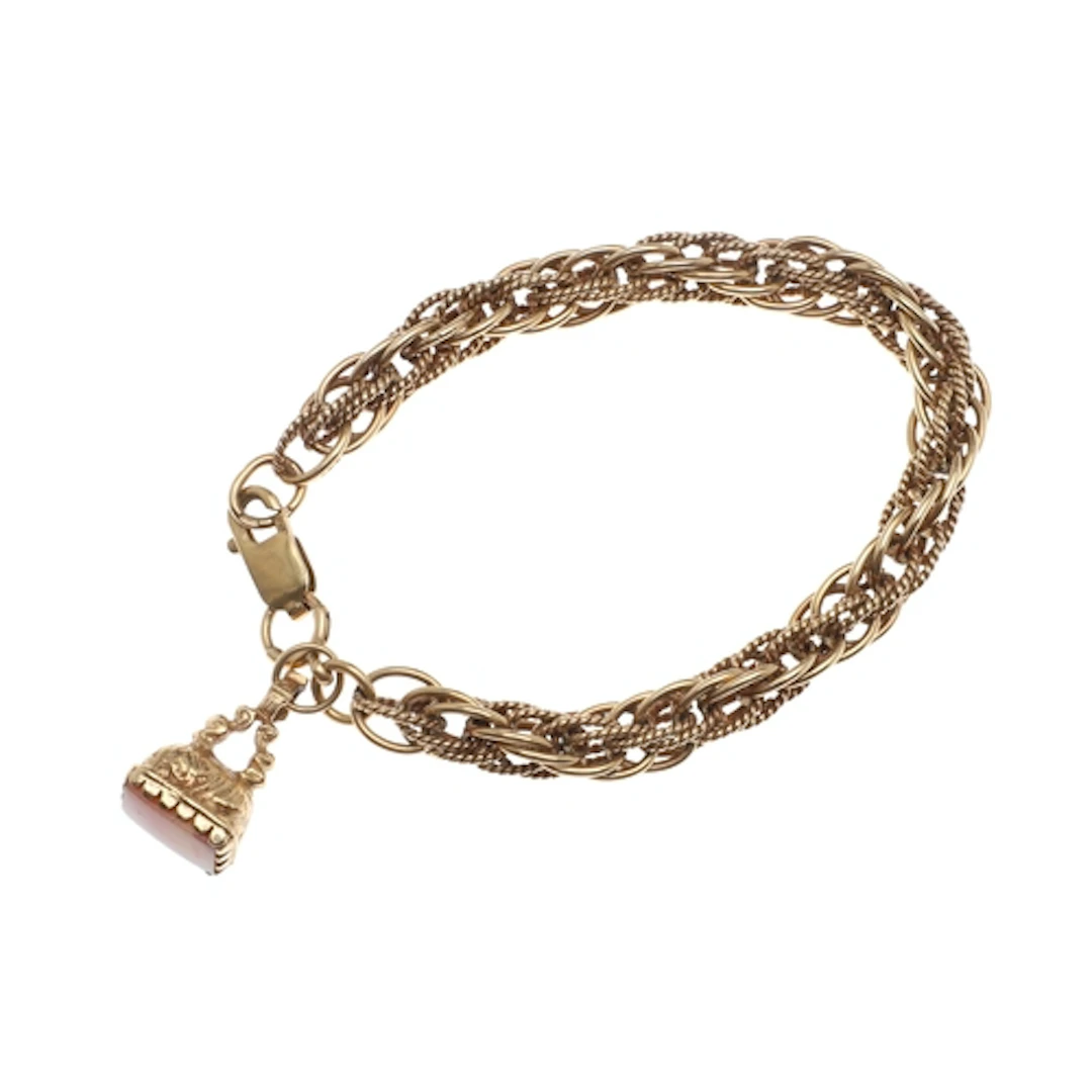 A 9CT GOLD FANCY LINK BRACELET. suspending a gold fob, with ...