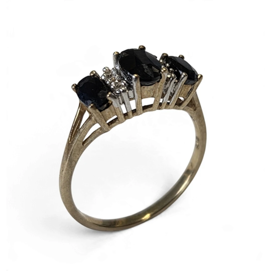 A vintage 9-carat gold sapphire and diamond trilogy ring, th...