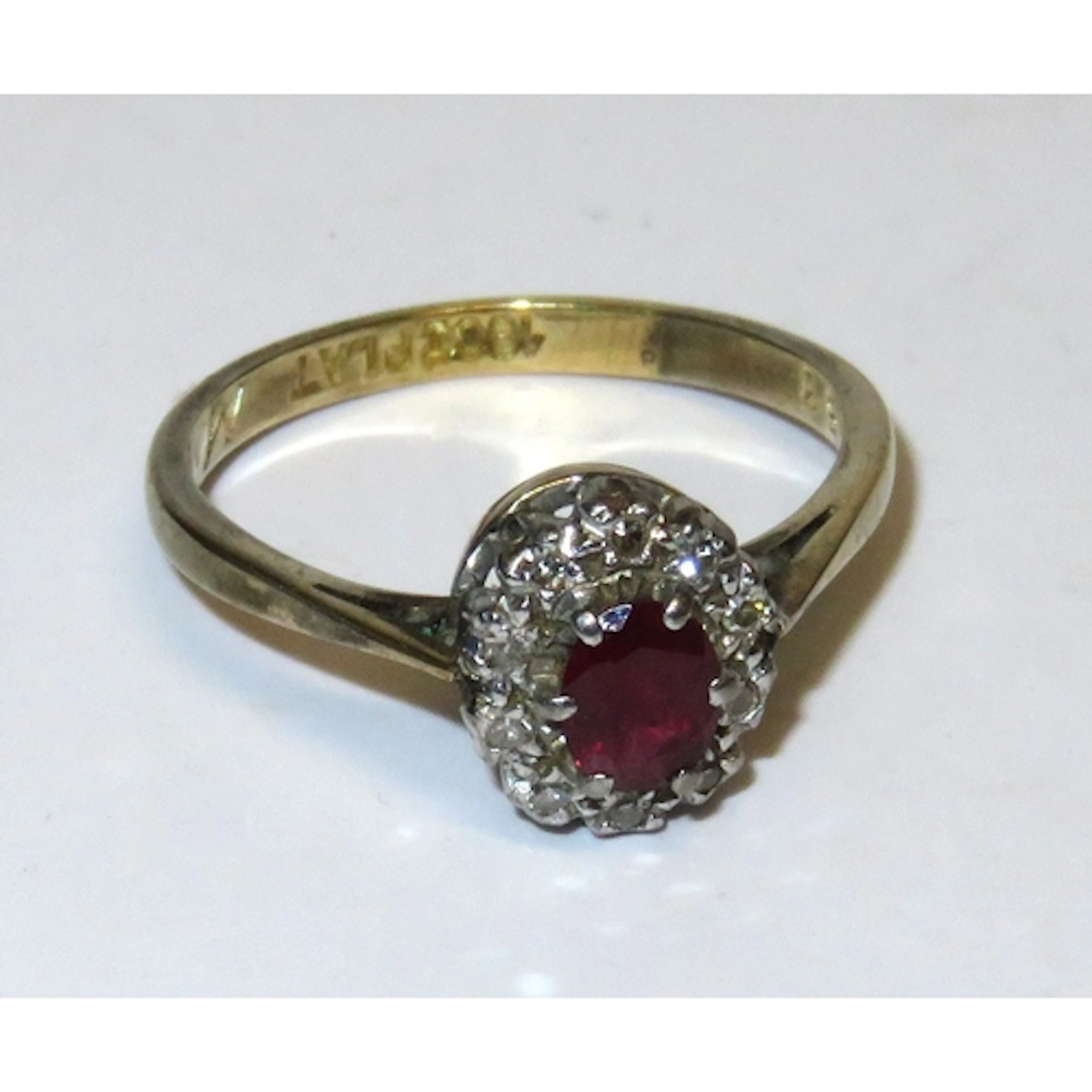 18ct Gold and platinum oval ruby and diamond cluster ring, s...
