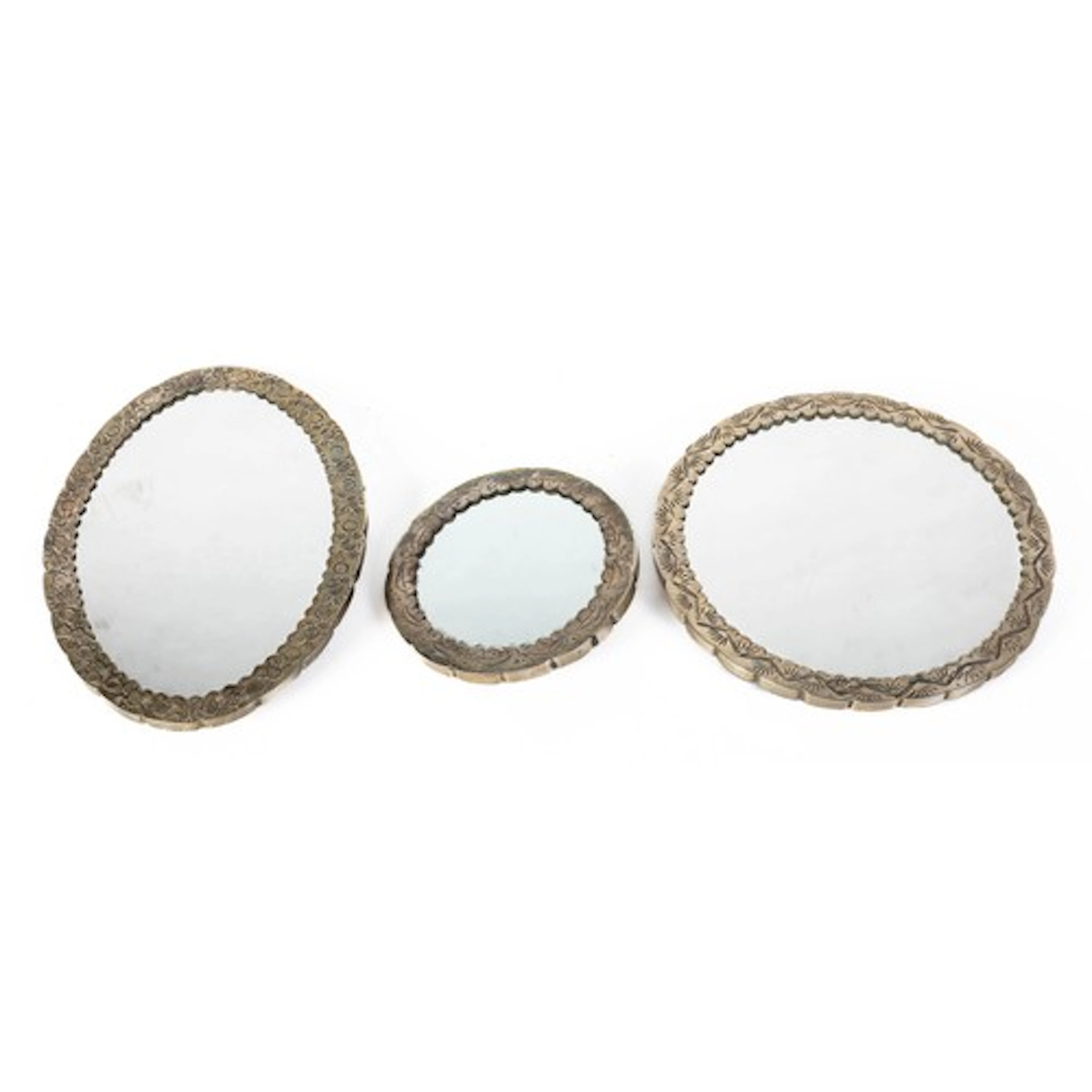 Three South Asian white metal mounted vanity mirrors, emboss...