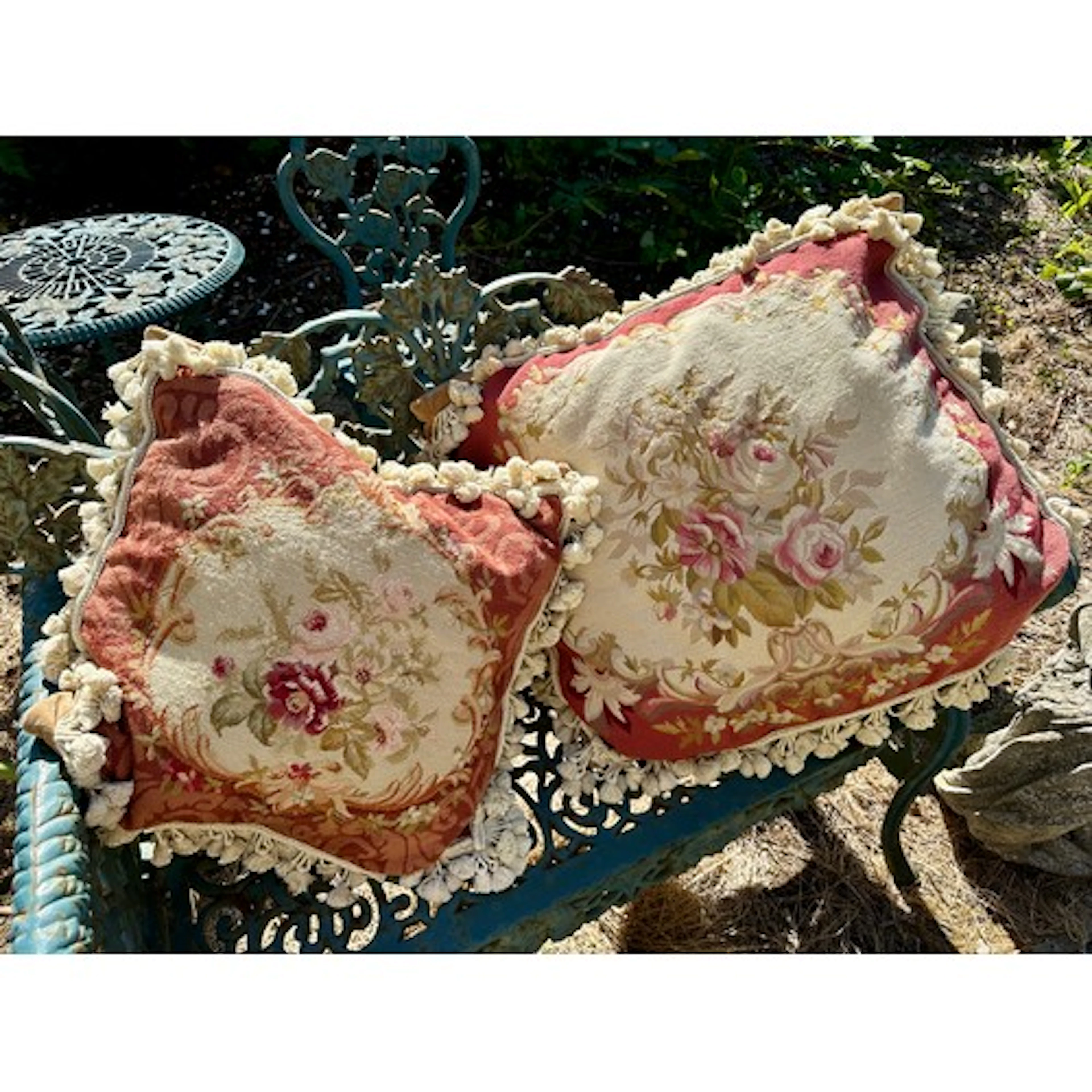 Two wool worked cushions with floral design and tassels. Lar...