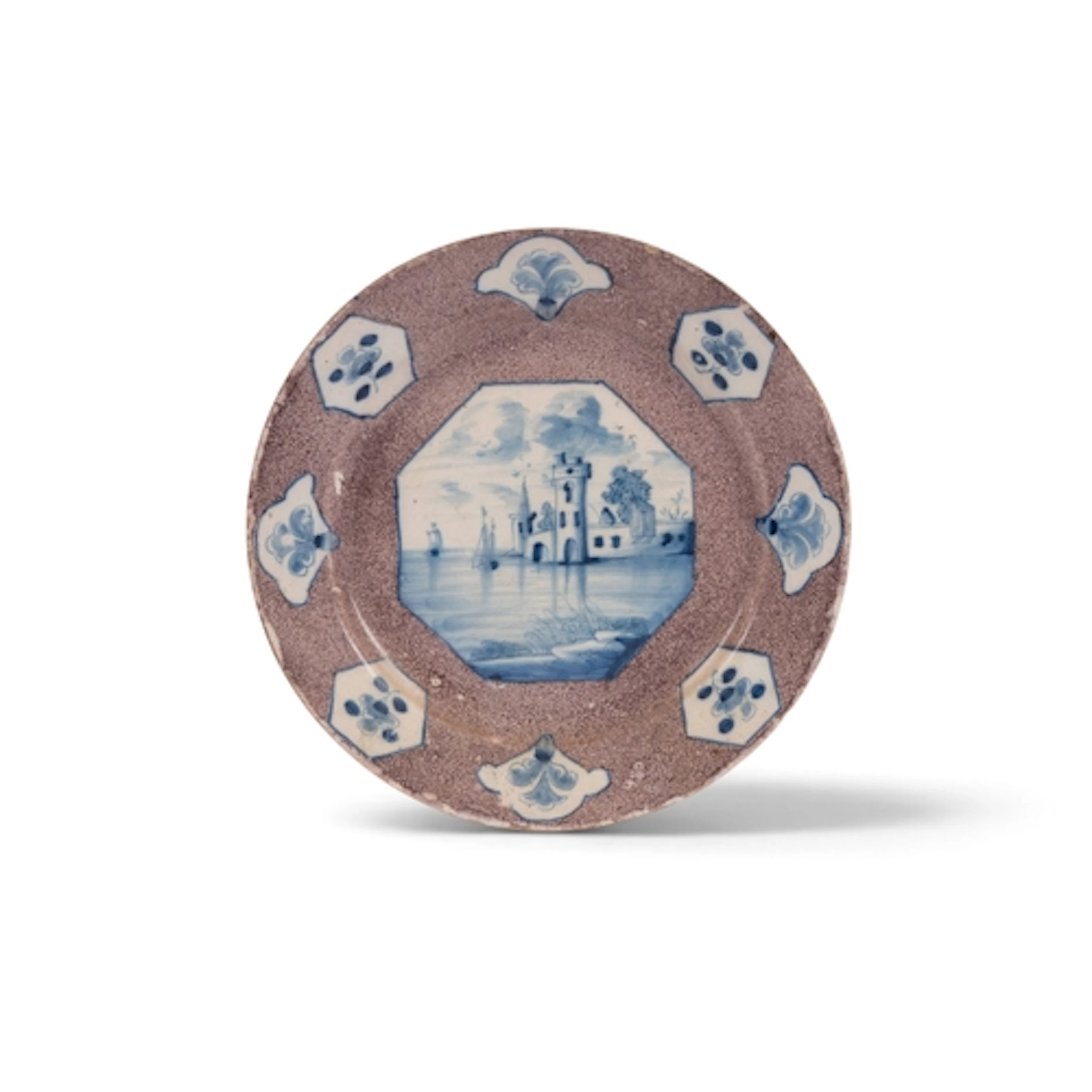 A Wincanton delftware plate, c.1740, the well painted in blu...
