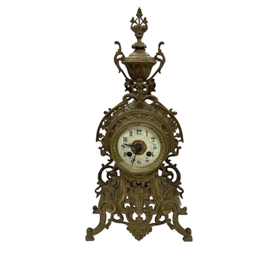 A French gilt-metal mantel clock, with pierced foliate desig...