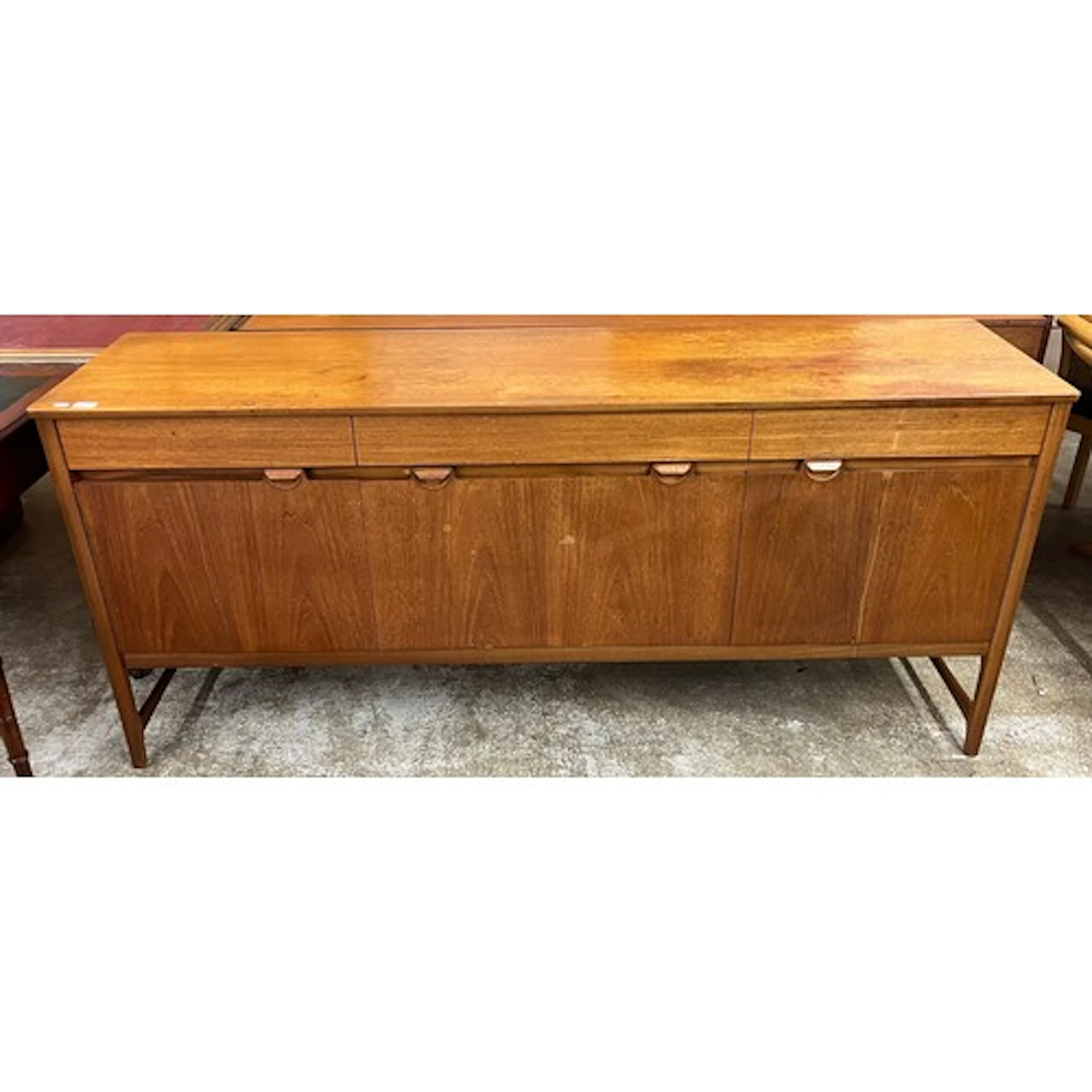 Mid-century teak sideboard with a central drop-leaf door fla...