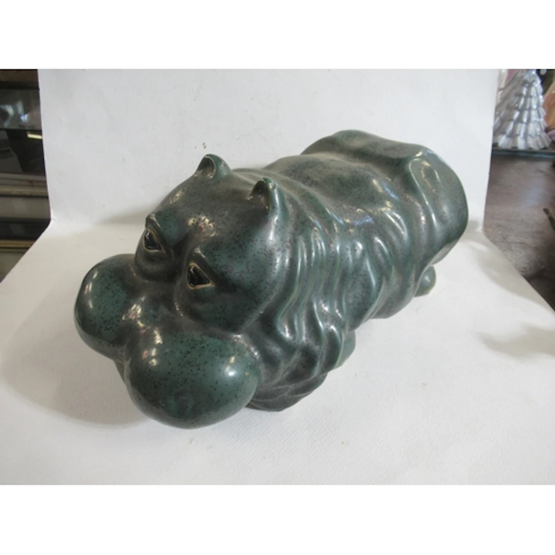 A pottery model, of a hippo with green glaze, length 14ins