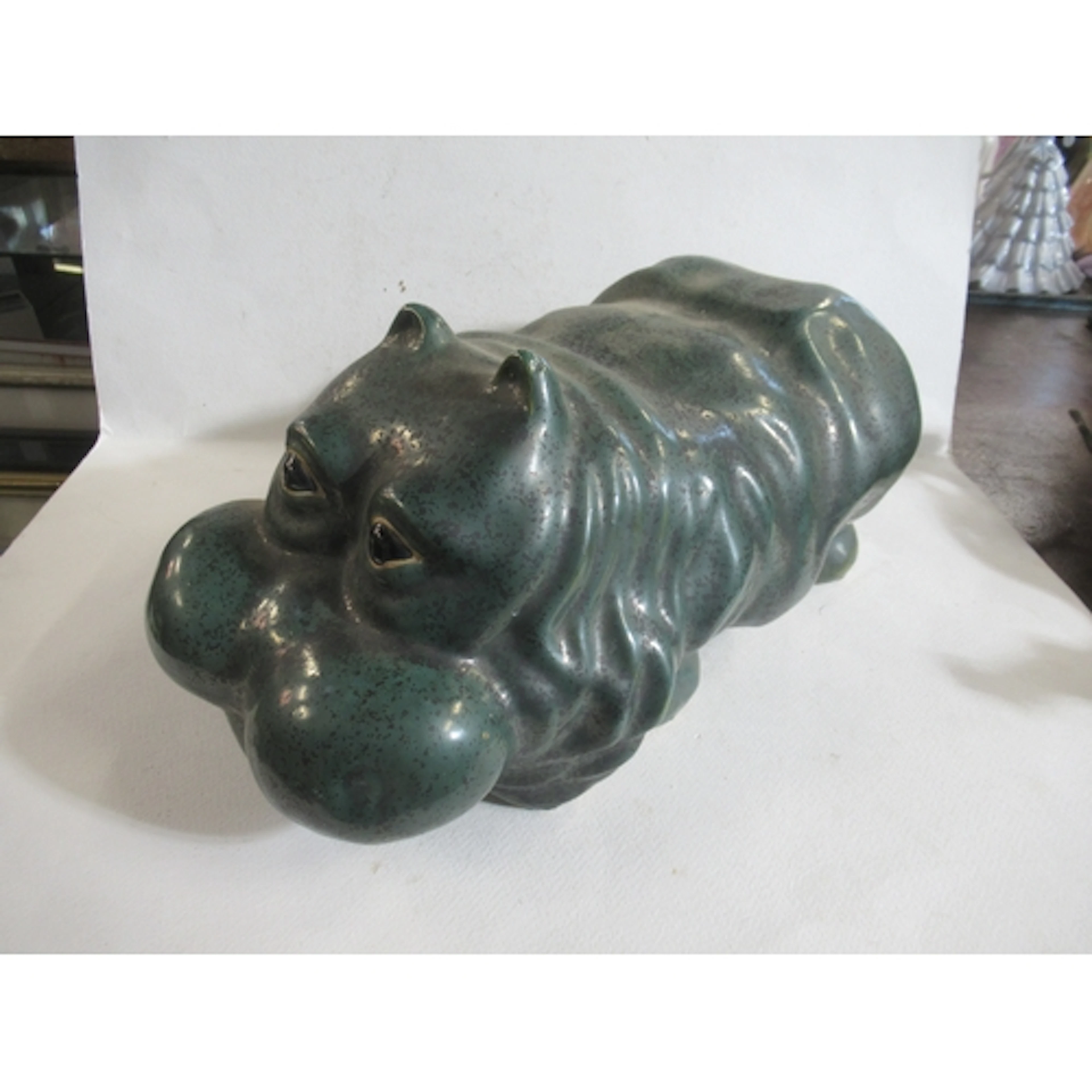 A pottery model, of a hippo with green glaze, length 14ins