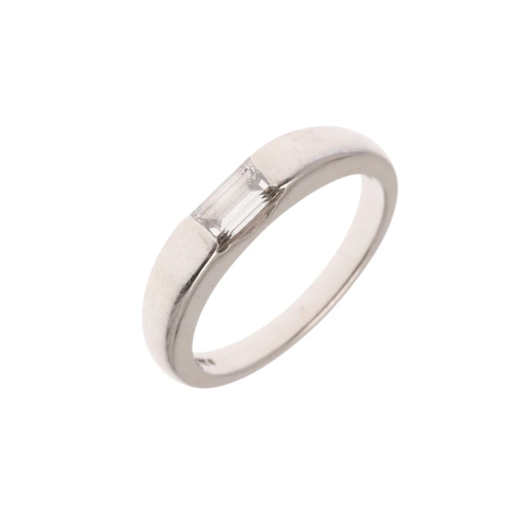 A DIAMOND AND PLATINUM RING. the platinum band is set with a...