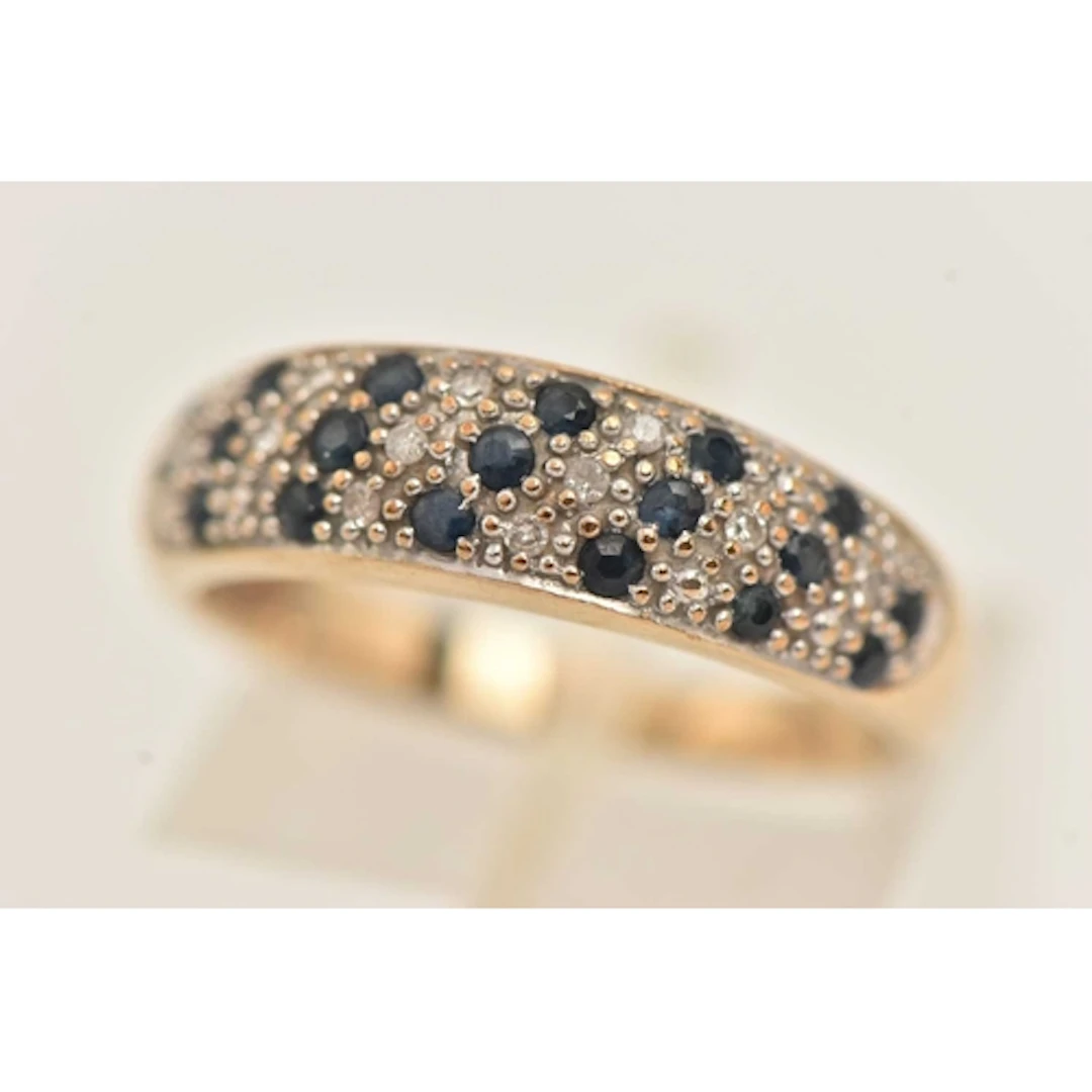 A 9CT GOLD SAPPHIRE AND DIAMOND RING, pave set with small si...