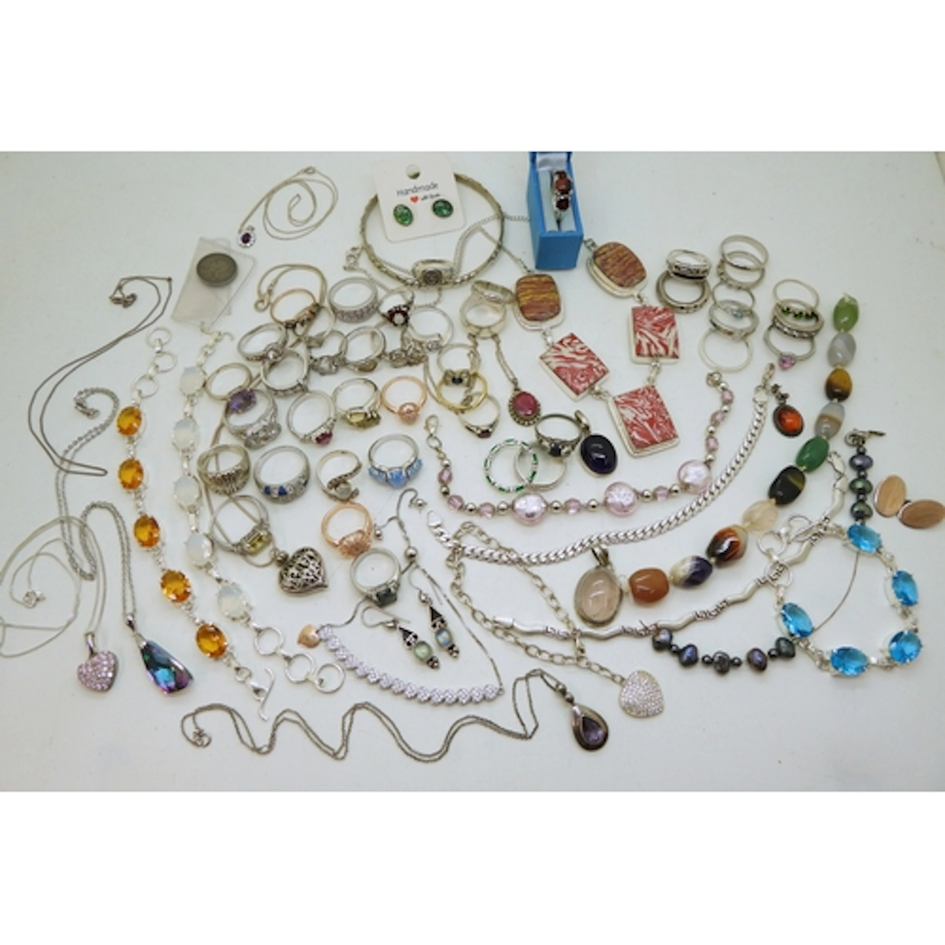 A large collection of silver and white metal jewellery to in...
