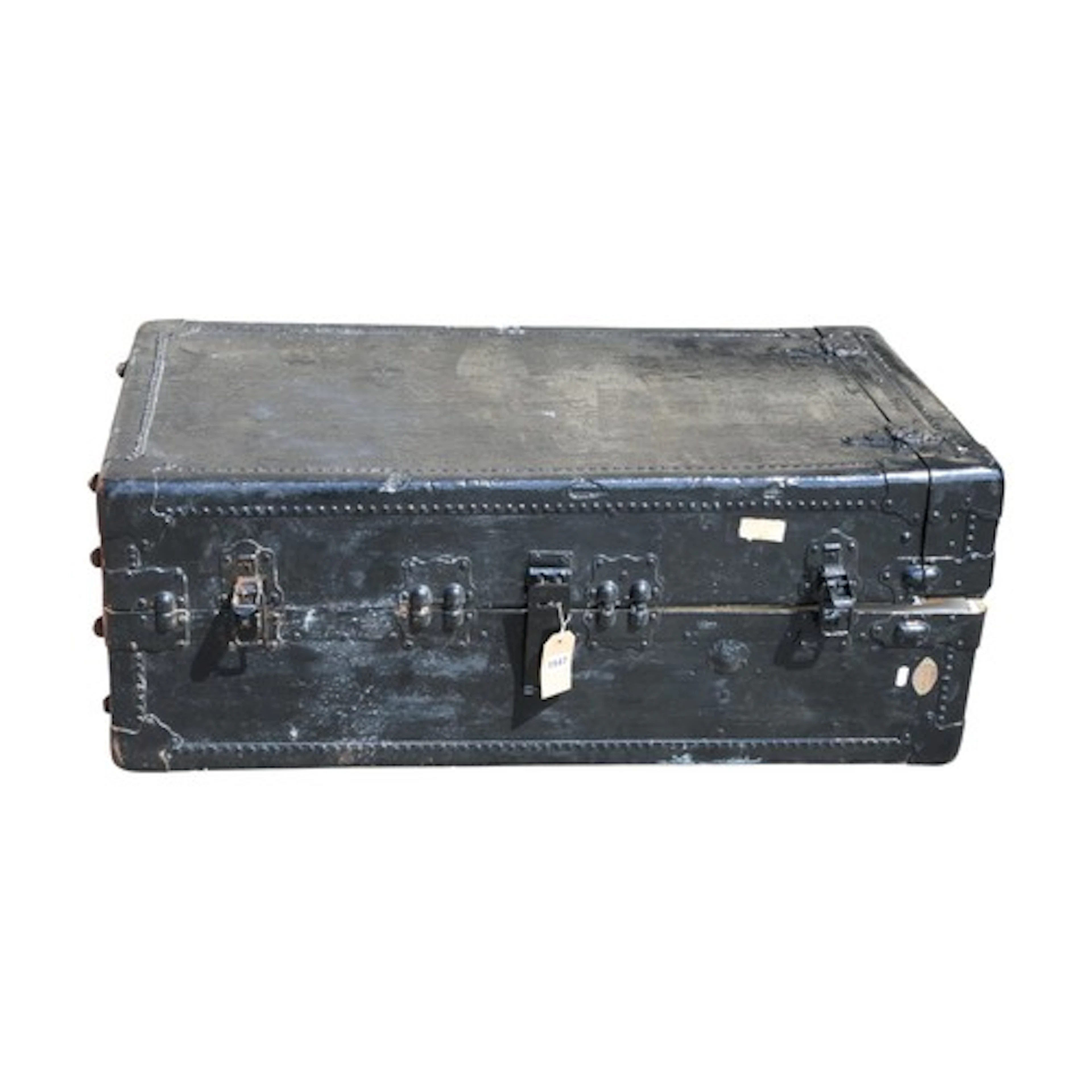 A large old black-painted travelling trunk, with applied bra...