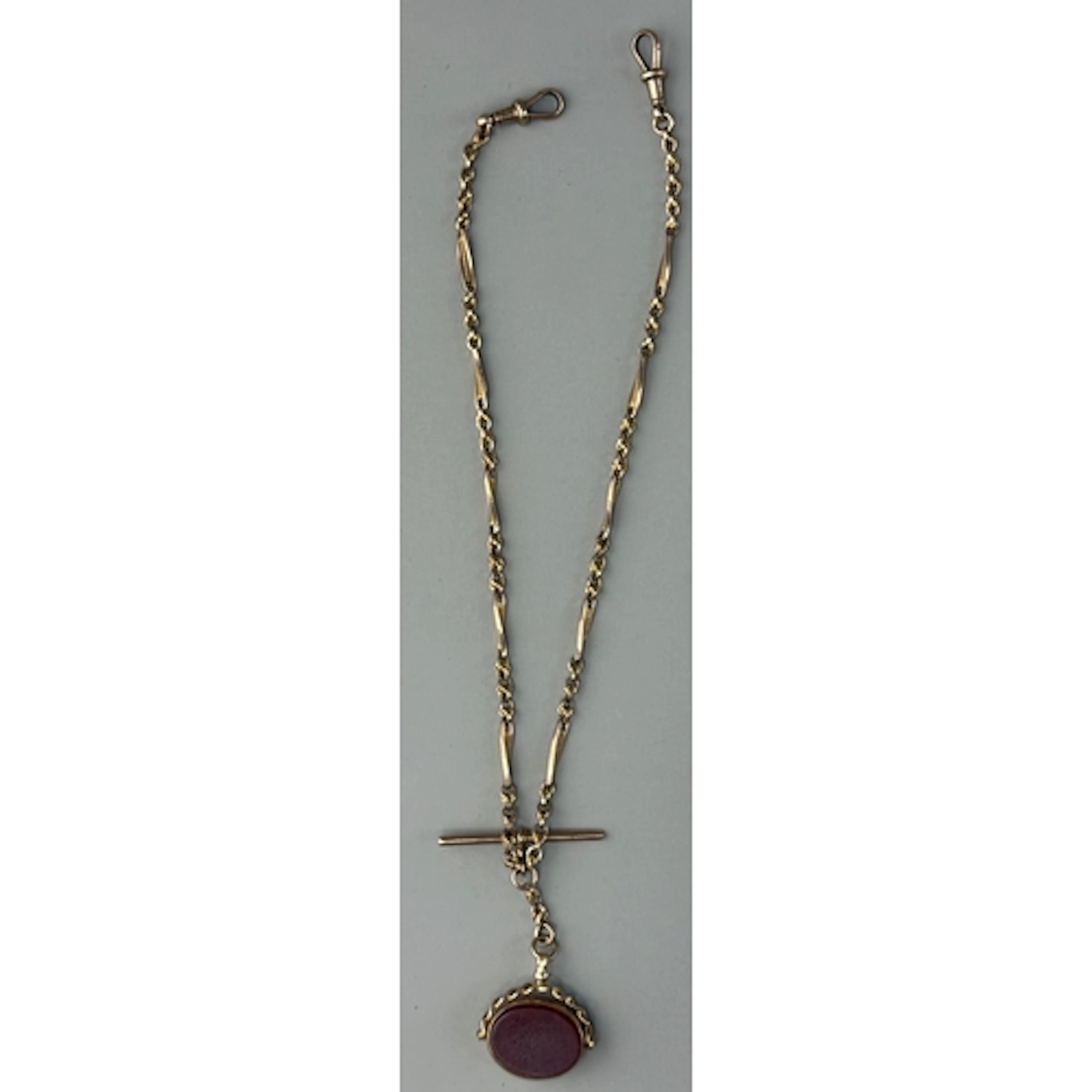 Jewellery: a 9ct yellow gold bar and knot double Albert watc...
